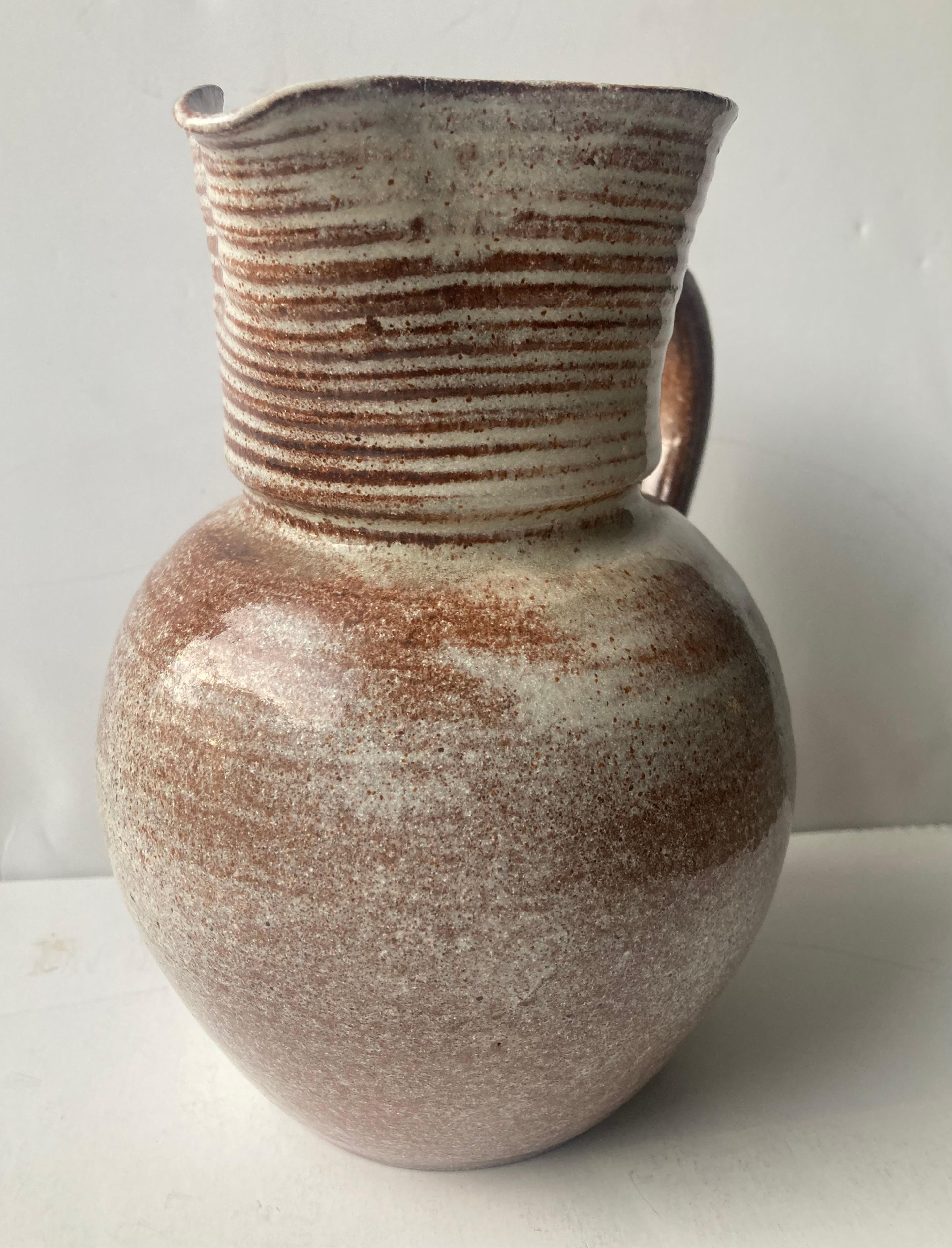 Very nice and elegant ceramic pitcher by the well known potter Laura Andreson .
