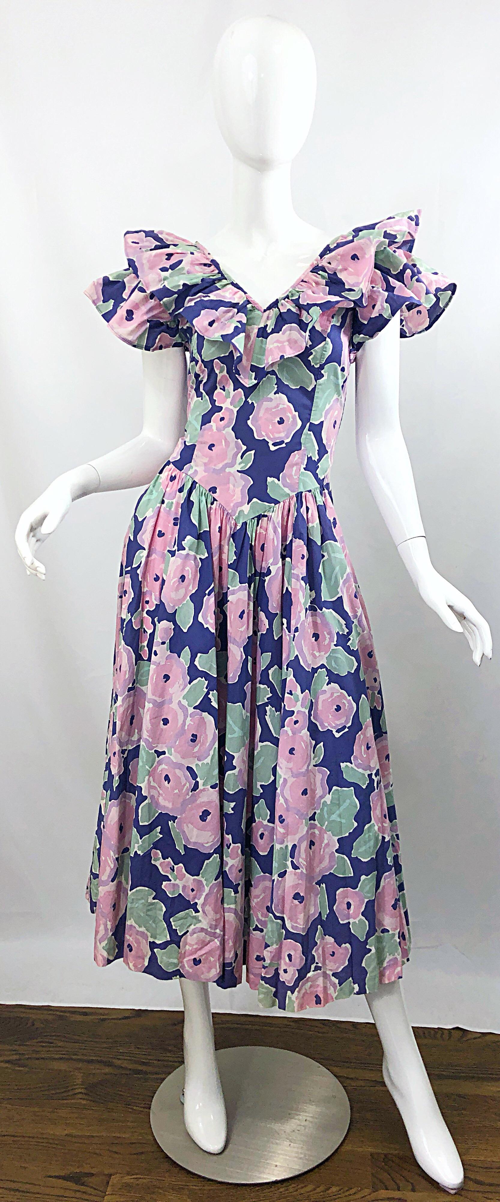 Rare and iconic early 1980s LAURA ASHLEY Batsheva Avant Garde purple, pink and green cotton midi dress! Features the signature Ashley floral print. Great double layer of ruffled sleeves. POCKETS at each side of the hips. Fitted bodice with a free
