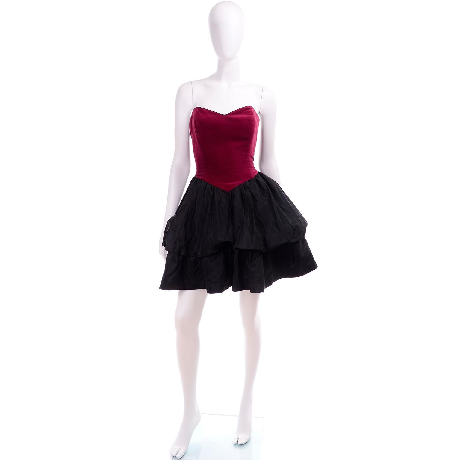 This vintage Laura Ashley dress would make a perfect holiday party dress!  The dress has a raspberry red velvet bustier style bodice with boning for structure. The full skirt is black taffeta with a tiered bubble effect. The dress closes in the back