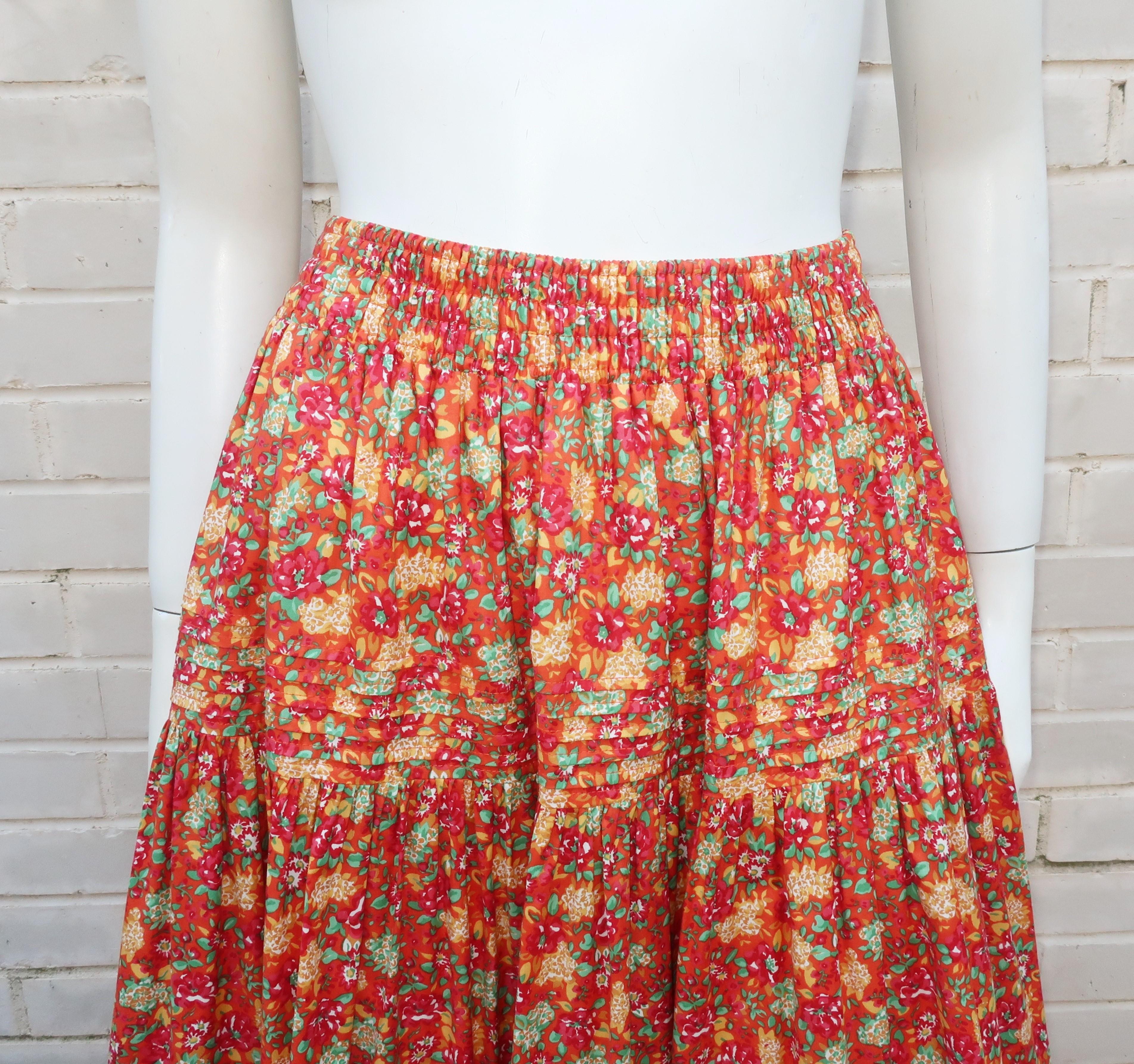 1980's Laura Ashley floral cotton skirt with a prairie style silhouette.  The pull-on construction has an elasticized waistband and tiers with two sections of pin tucking.  The full skirt and floral print in shades of orange, red, yellow and green