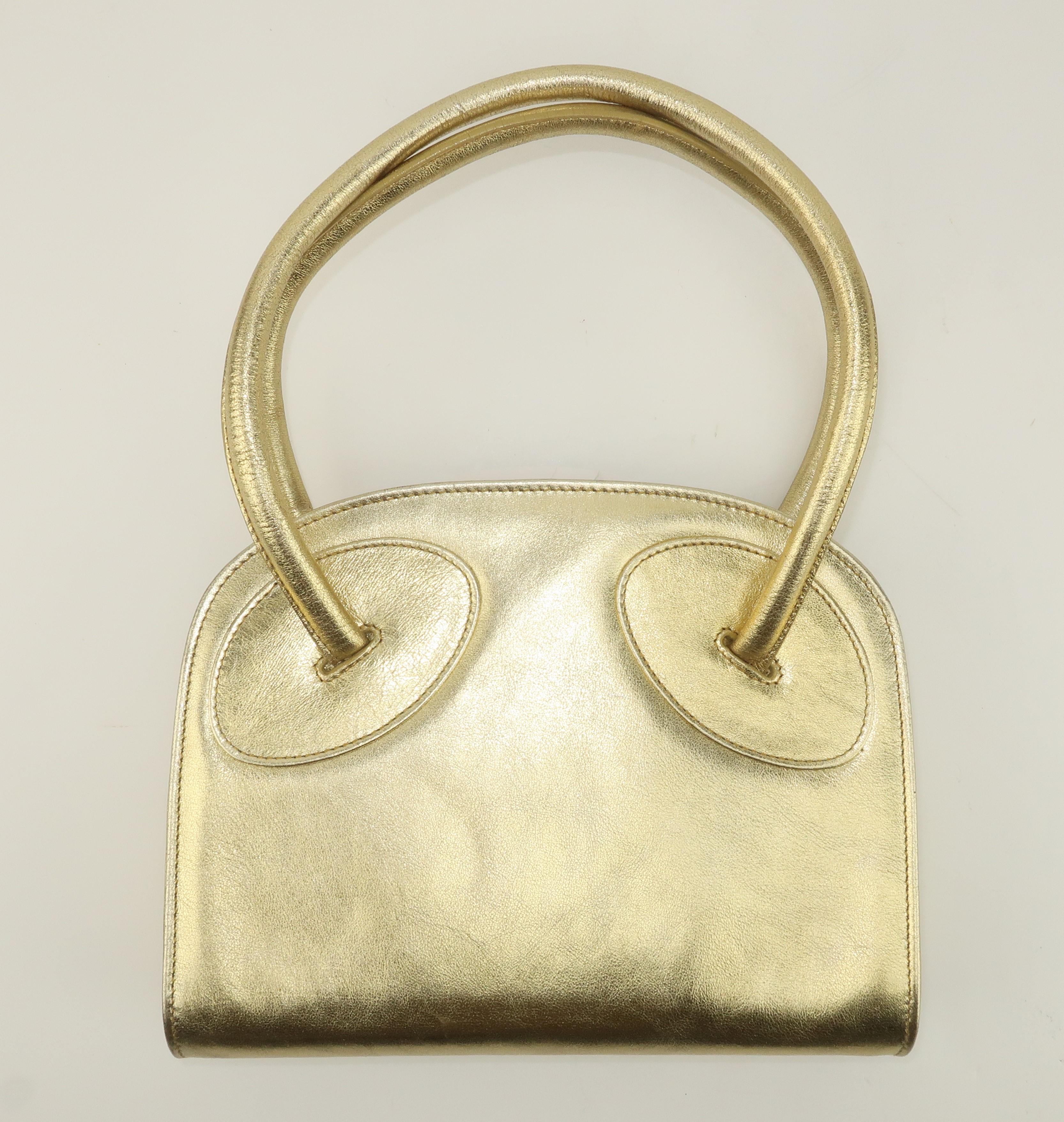 Glamorous gold ... Italian style!  This gold nugget is a 'carry anywhere and with everything' bag.  It is ostensibly an evening accessory but the effortlessly chic leather design would be the perfect pop to day wear, as well.  The 1970's silhouette