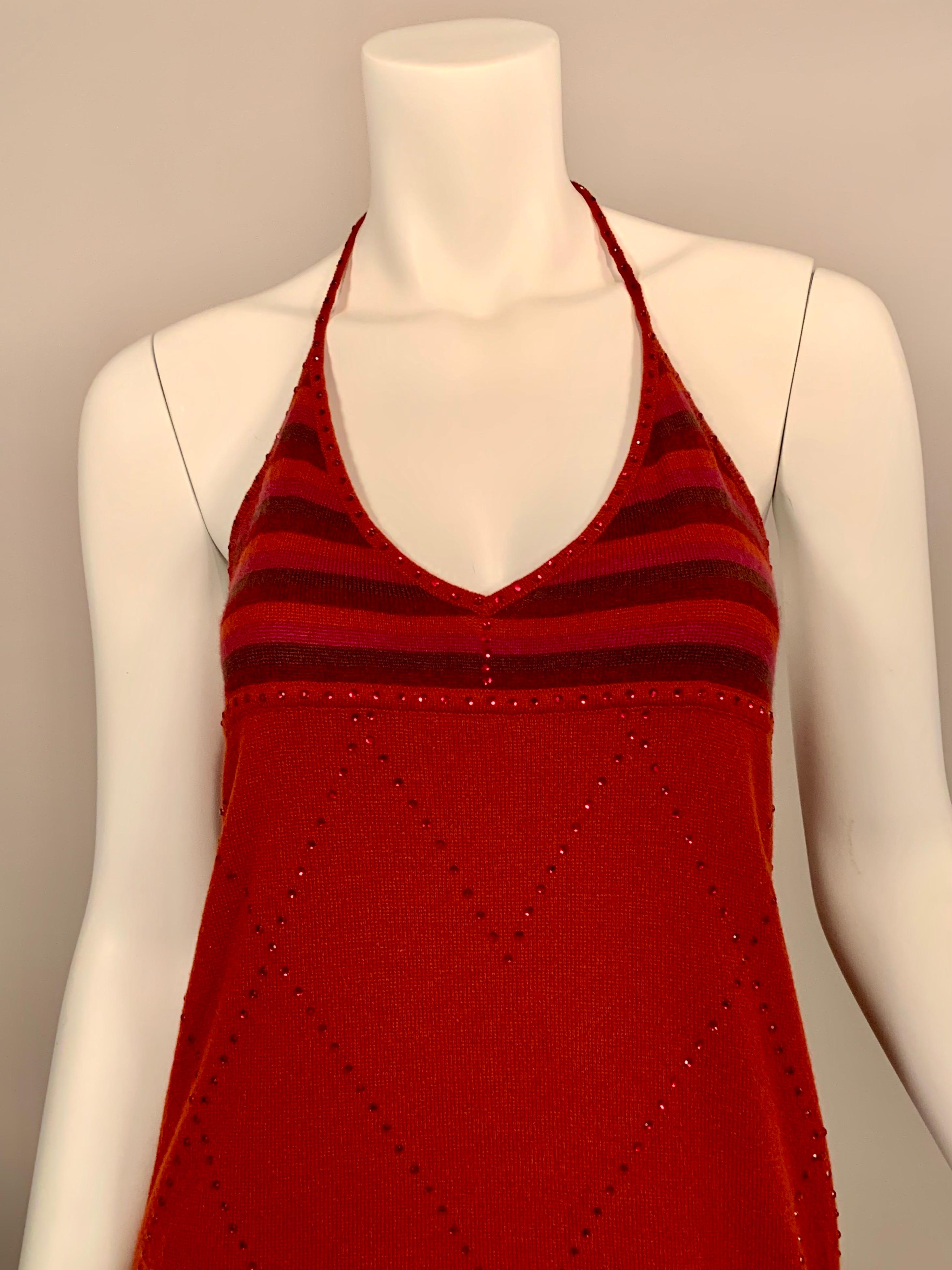 A stunning cashmere halter dress by Laura Biagiotti is covered with deep red rhinestones, adding a subtle sparkle. The dress has an Empire waistline with the top of the dress made from a subtly striped cashmere. The neckline and straps are edged in