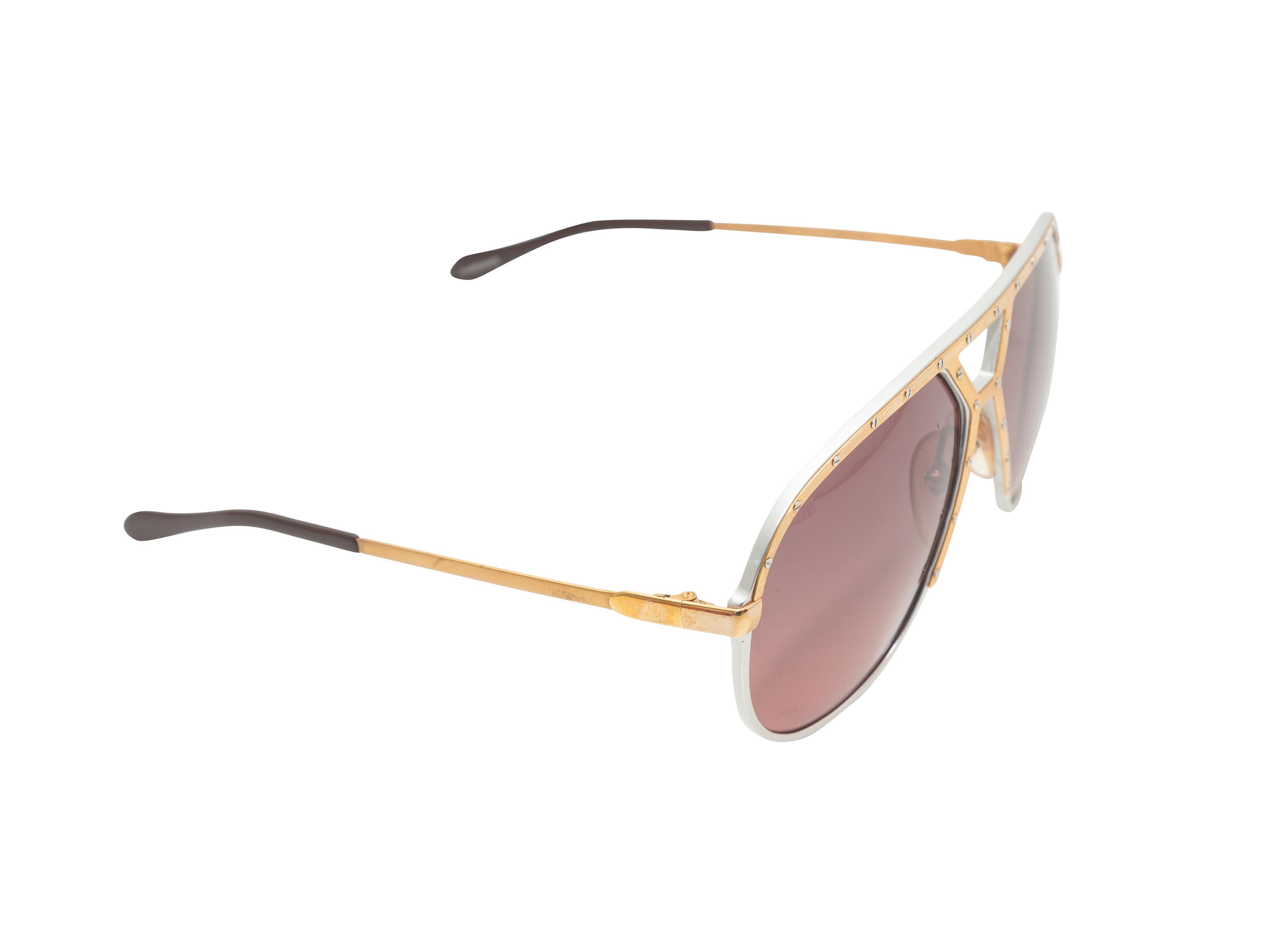 Product details: Vintage gold and silver oversize sunglasses by Laura Biagiotti. Pink tinted lenses. 2.25