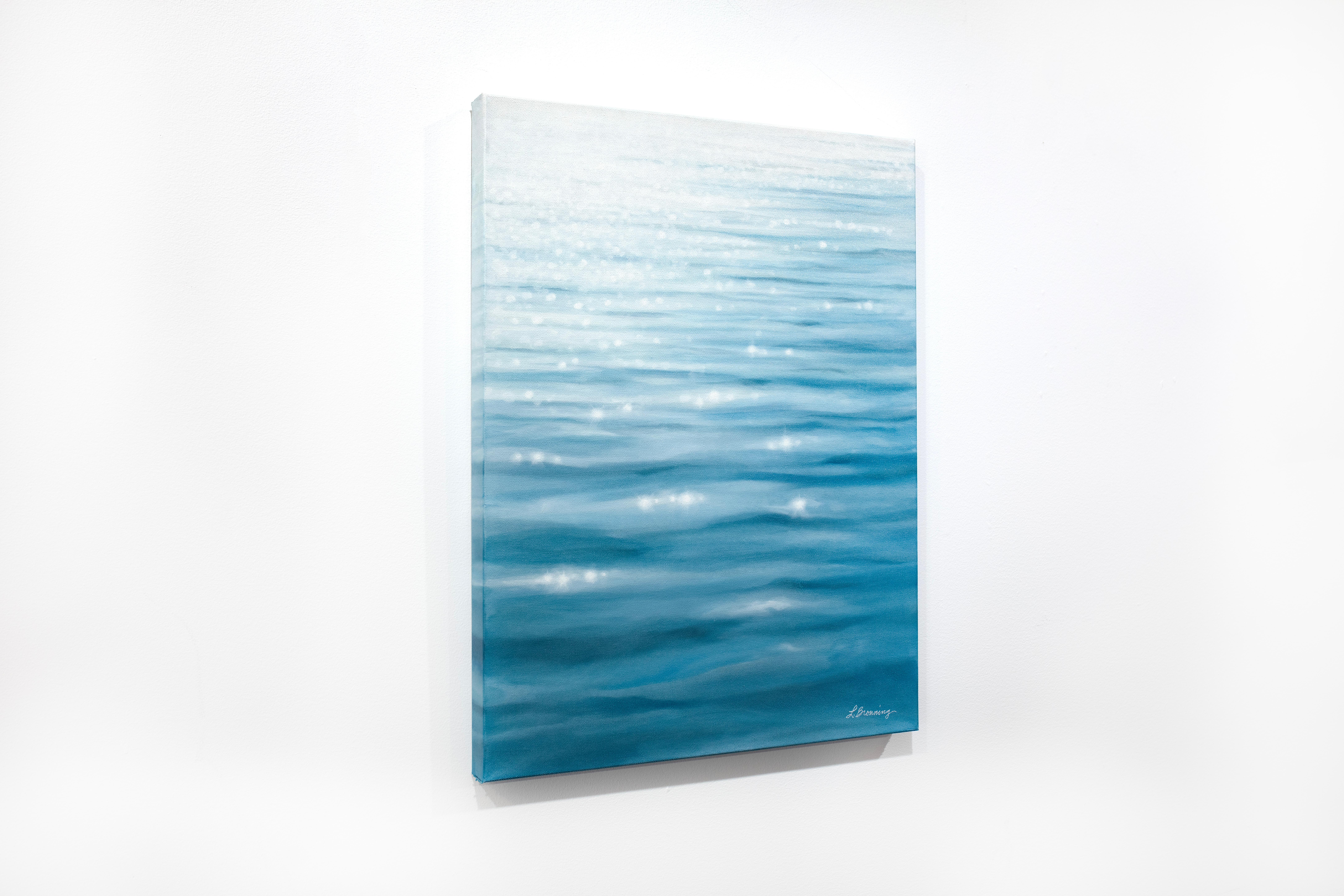This representational blue coastal oil painting by artist Laura Browning features a close-up cropped view of the surface of open water, with light glistening across it. It is made on gallery wrapped canvas with the painting continuing over the