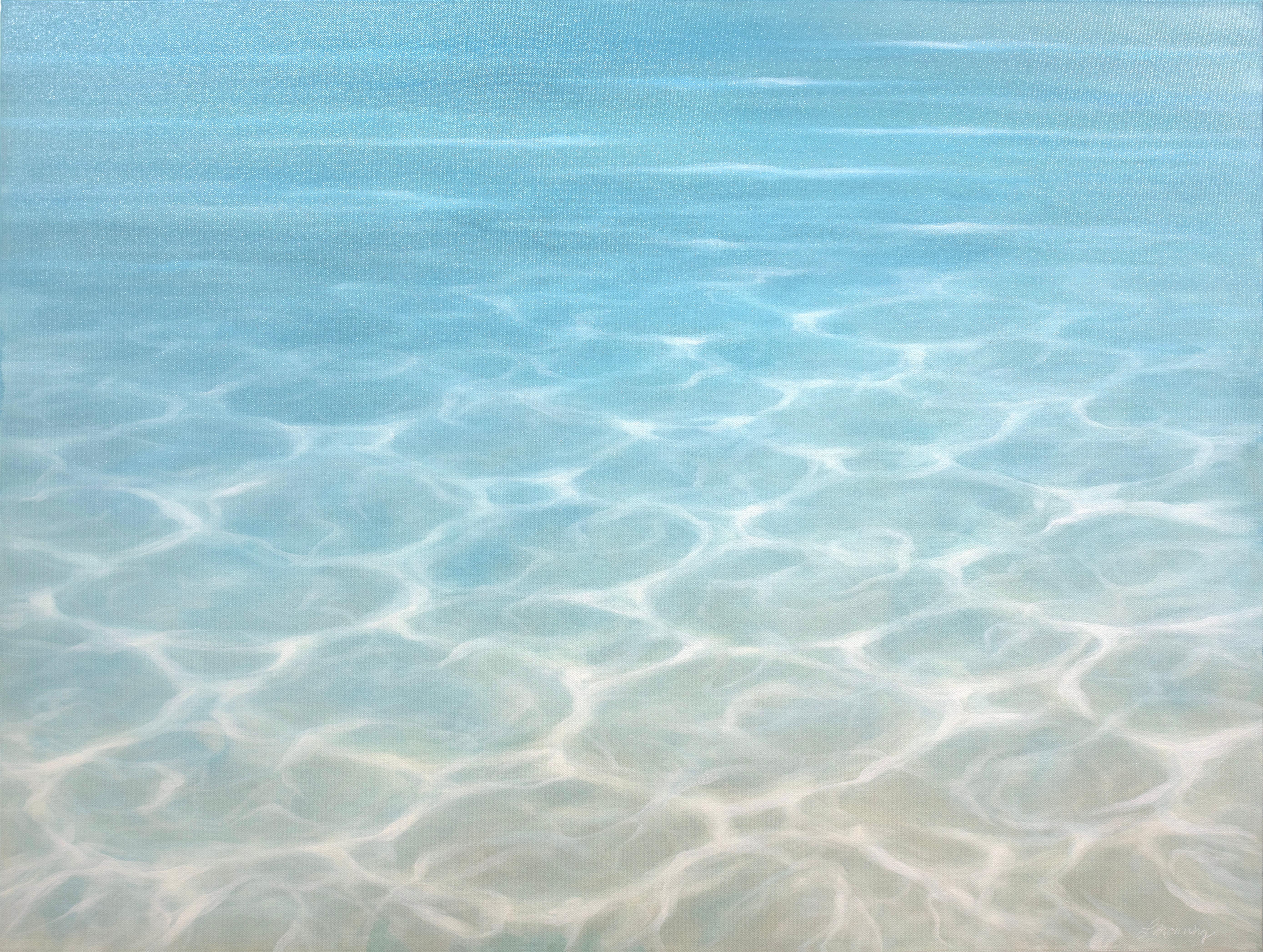 This representational blue coastal oil painting by artist Laura Browning features a close-up cropped view of the surface of open water, with light reflecting across it. The palette features a light, sandy undertone in the foreground that fades to
