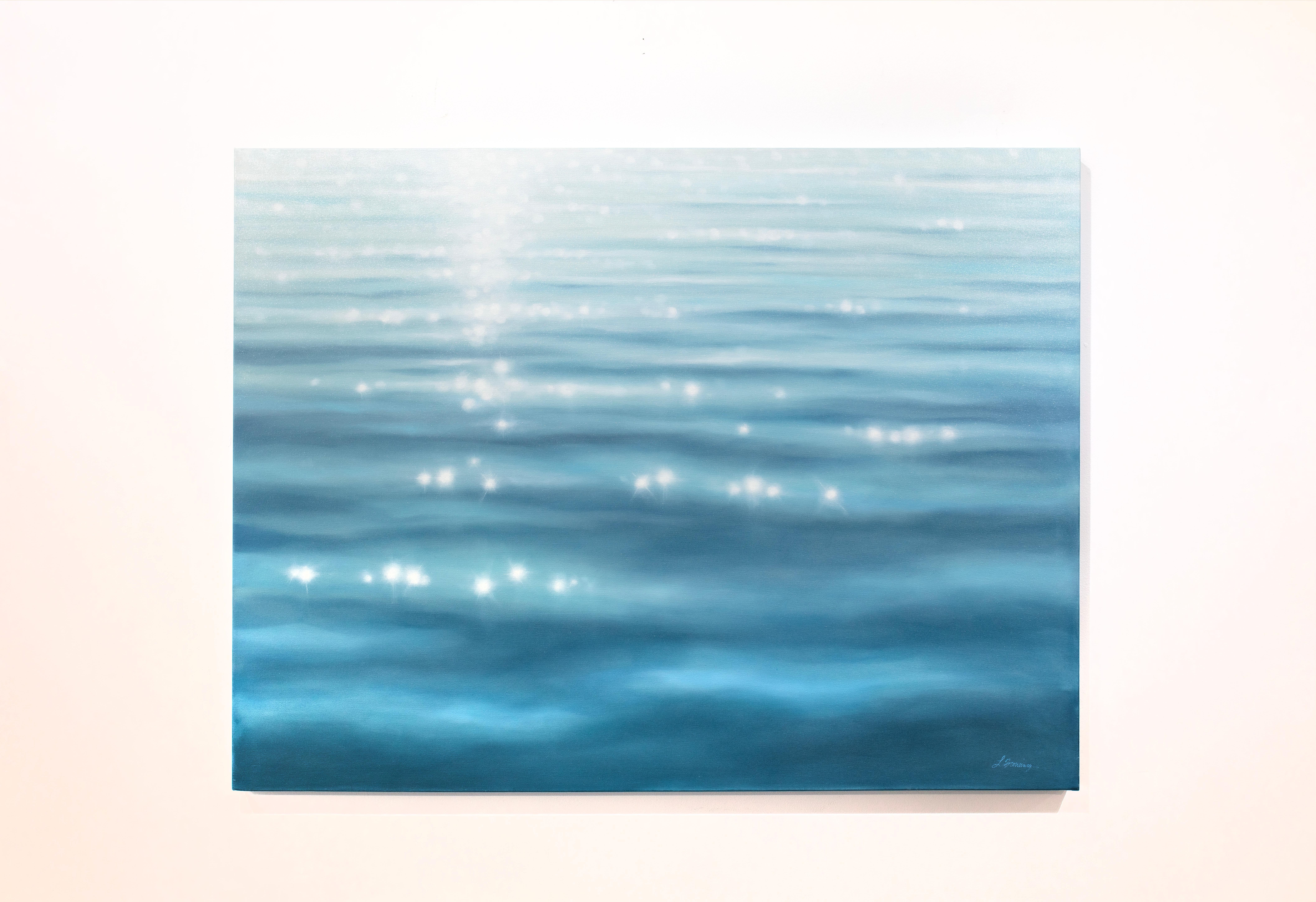 This representational blue coastal oil painting by artist Laura Browning features a close-up cropped view of the surface of open water, with light glistening across light waves. It is made on gallery wrapped canvas with the painting continuing over