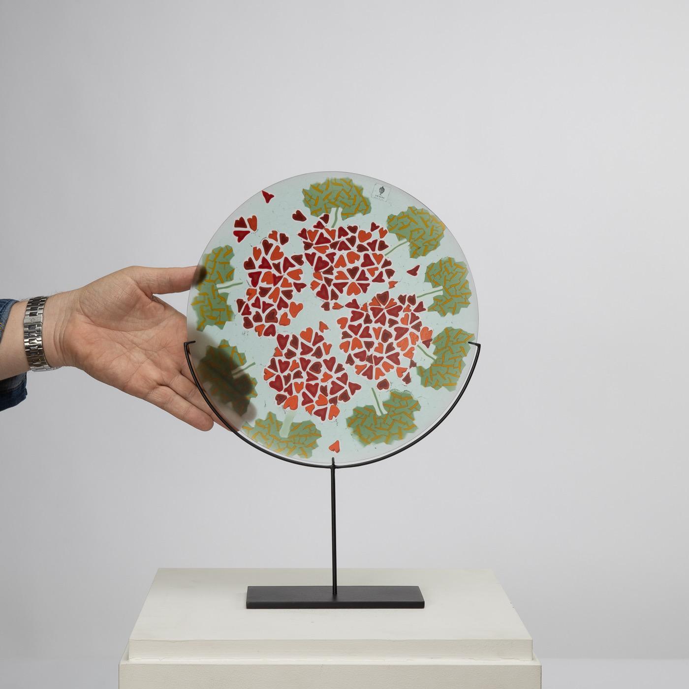 Hand welded and ground Murano glass plate with an arrangement of polychrome murrines
depicting the shape and colors of geraniums. 
This piece is one the 3 plates designed by Laura de Santillana of the series 