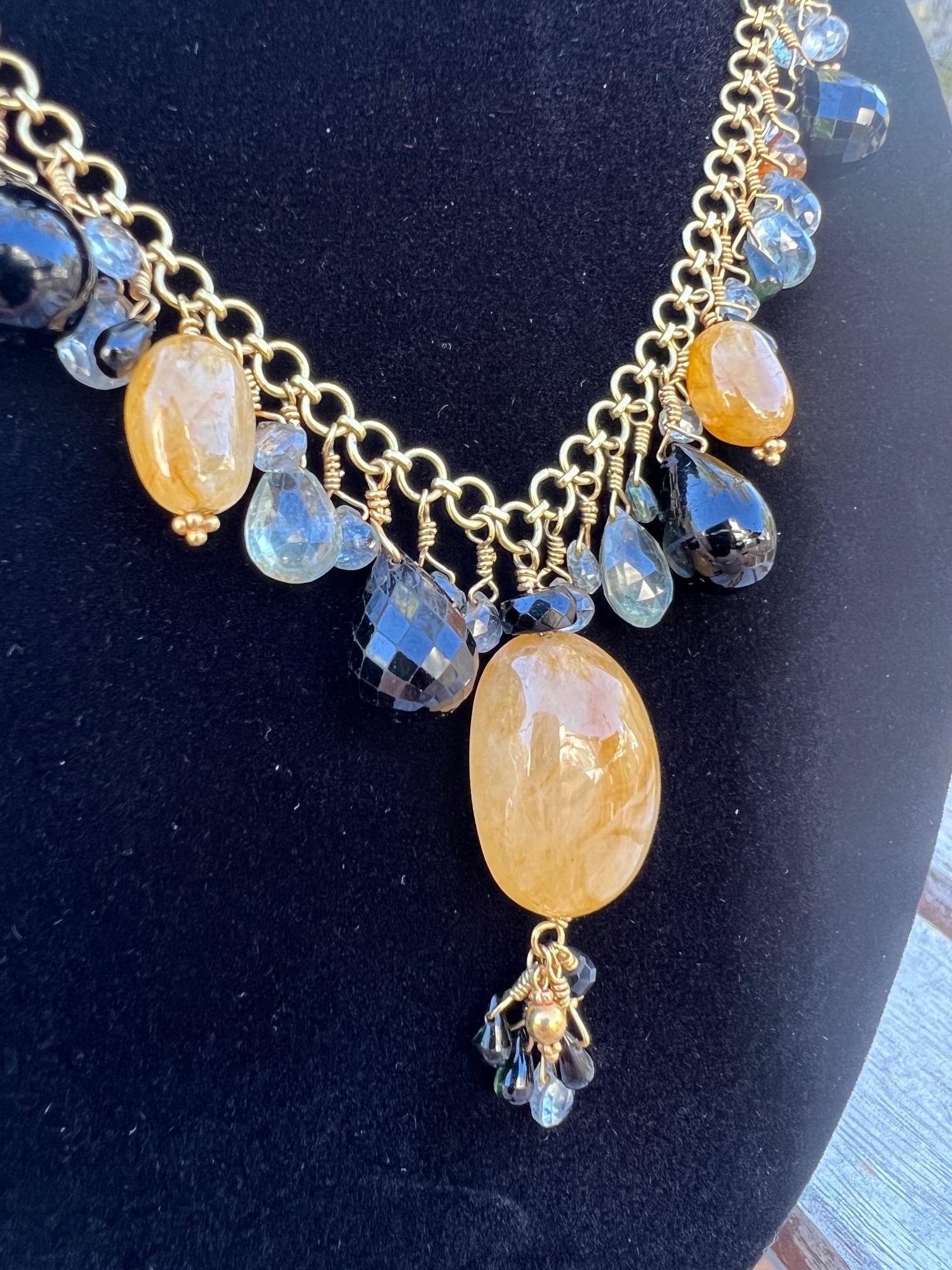 One of a kind multi gemstone necklace by Laura Gibson.  The details and craftsmanship on this necklace are exception.  The artist passed away in 2015.  A bio into her career and work is shared below. 

Polished orange Citrine
Balck Spinel
Blue