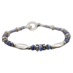 Pulsera Laura Gibson. Plata de ley y gemas facetadas colgantes - Topacio