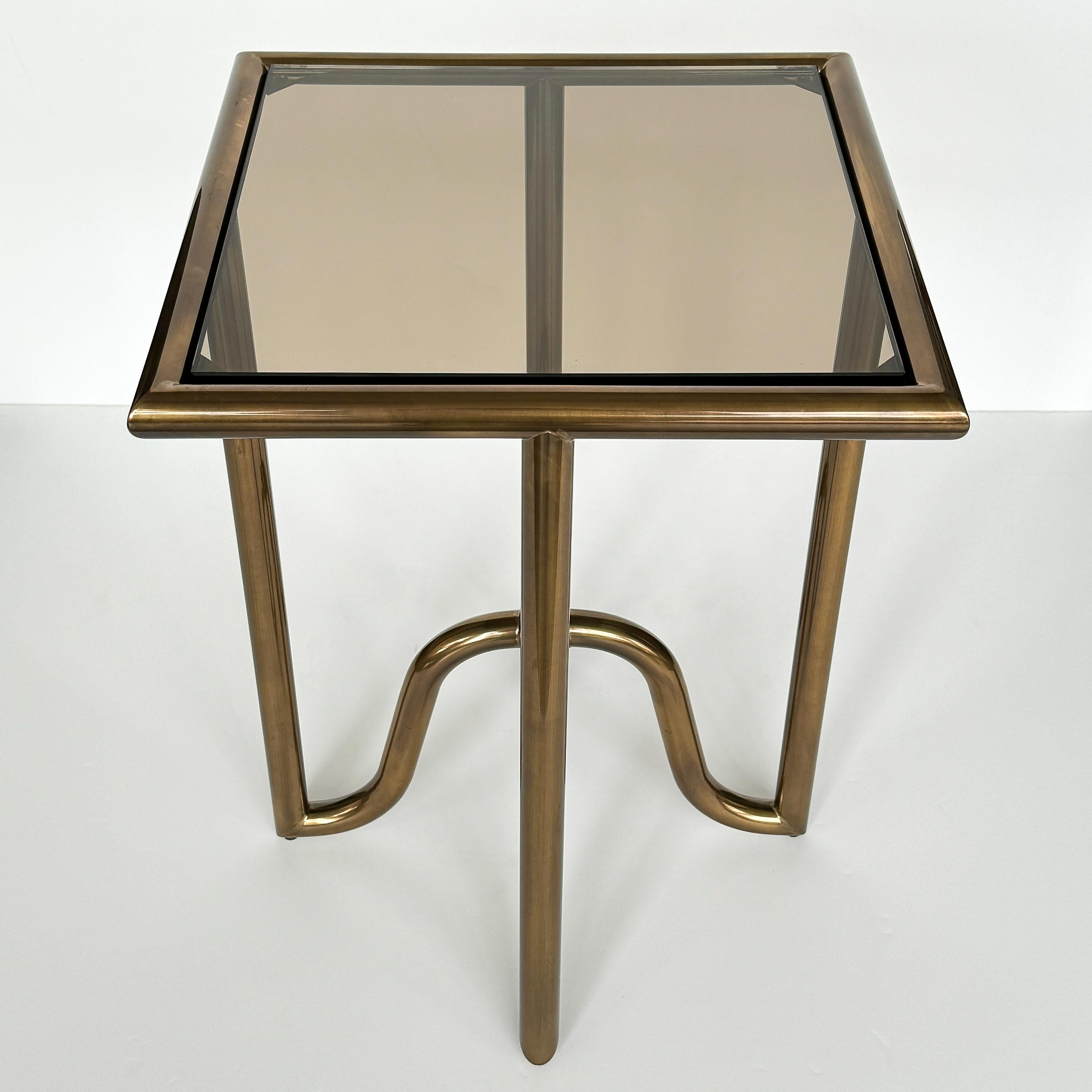 Introducing the Laura Kirar bronze Lien Tray side table for Baker Furniture, USA circa early 21st century. This exquisite piece boasts a lustrous tubular brass structure, 1