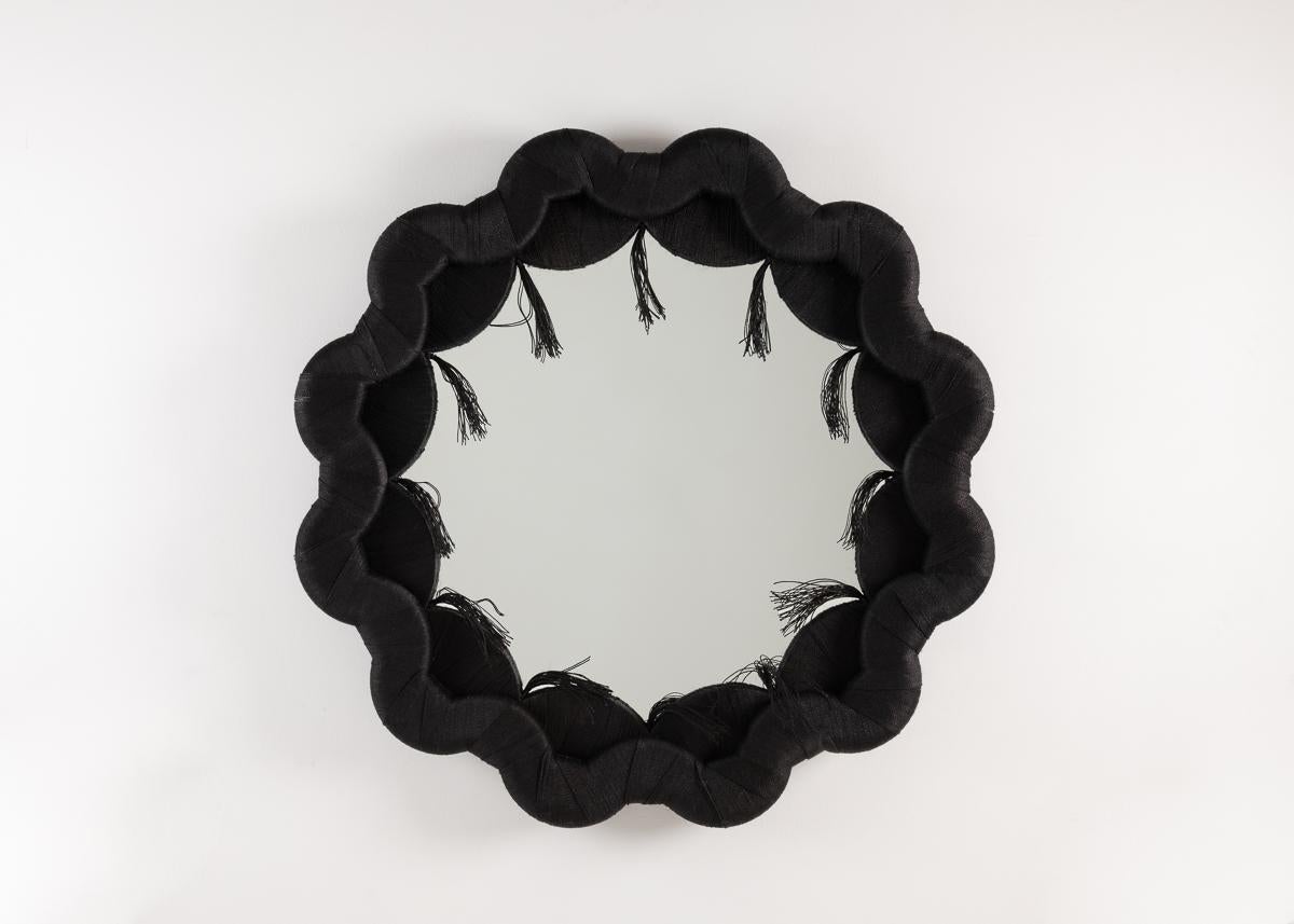 This remarkable mirror, with its repeating wood frame and well-placed tassels, speaks to designer Laura Kirar's deepl spiritual and physical connection to her adopted home of Mexico. The name, which signifies the history of the two cultures she