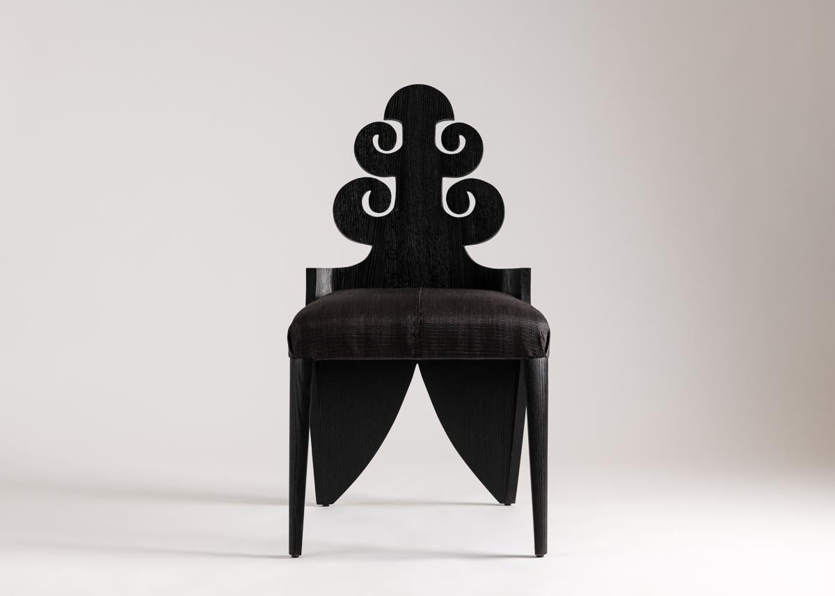 Laura Kirar took the Mexican scarabe as inspiration for this whimsical side chair carved of ebonized Spanish cedar. With the piece's broad splayed legs the artist intimates those of the insect, and with its beautifully symmetrical, swirling back,