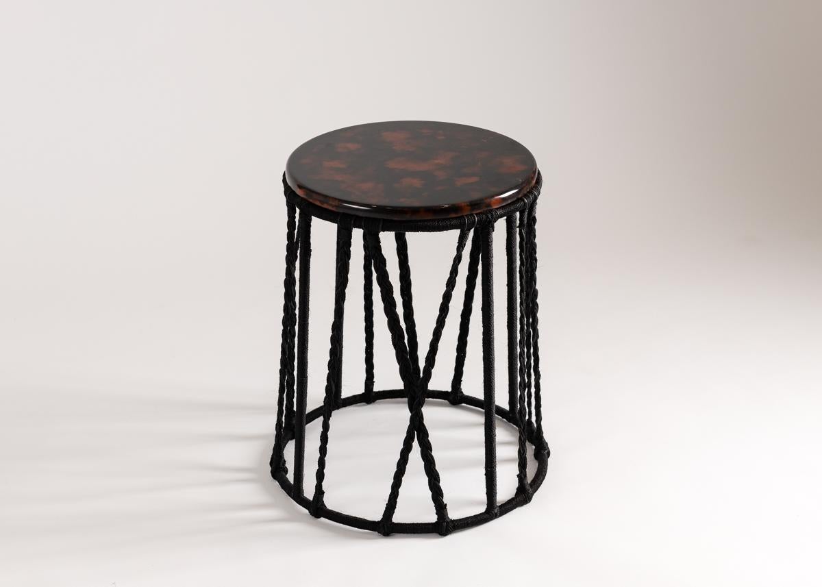 Laura Kirar's geometric occasional tables have tops of multicolored resin and bases of steel covered in lengua de vaca hemp braiding. These remarkable little pieces, with their locally sourced materials and dependence on regional techniques, serve