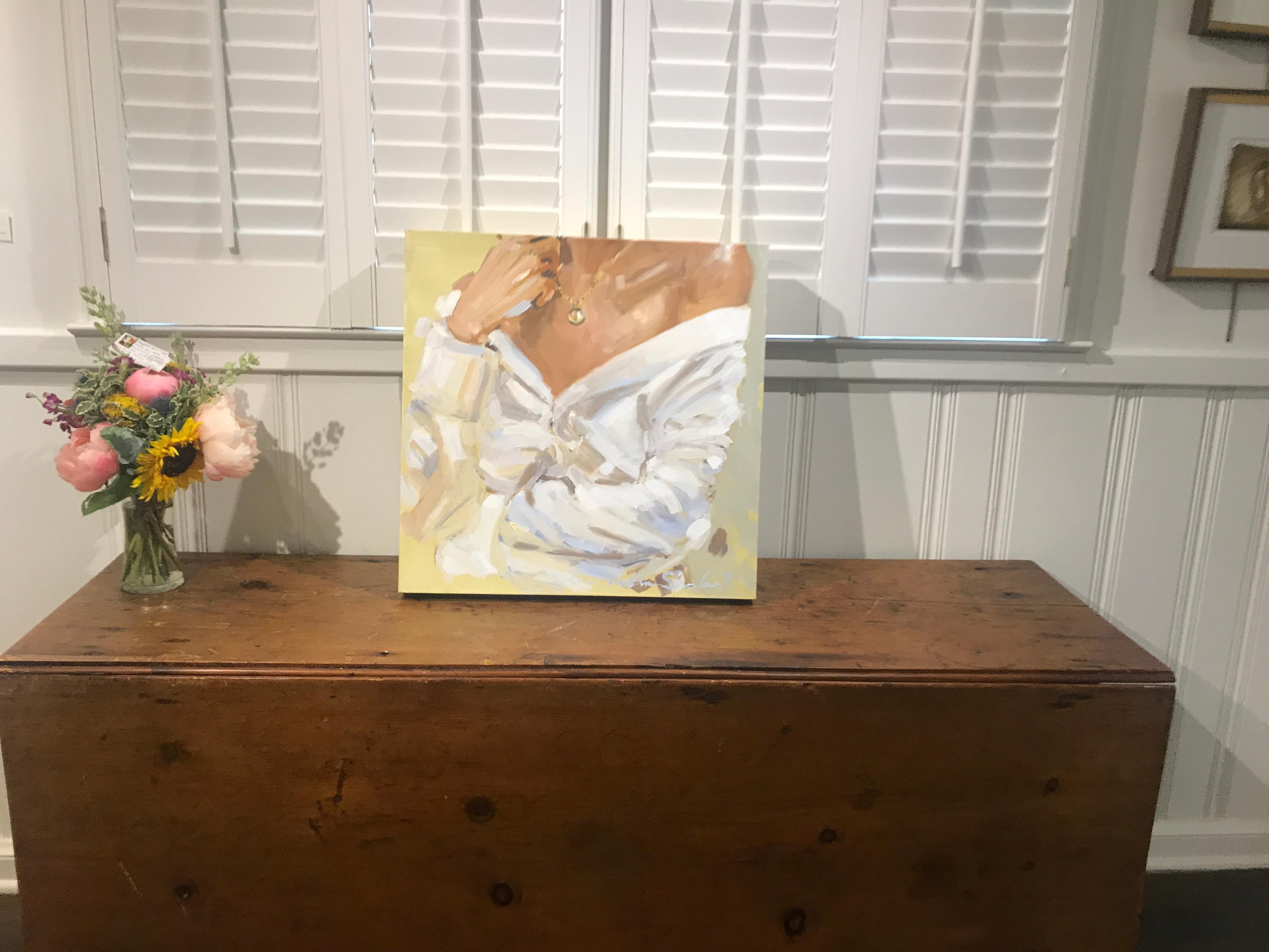 'Folded Arms' is a small Impressionist oil and acrylic on canvas painting created by American artist Laura Shubert in 2019. Featuring a palette made of brown, pink, white and golden tones, the painting depicts the bust of a woman dressed in white