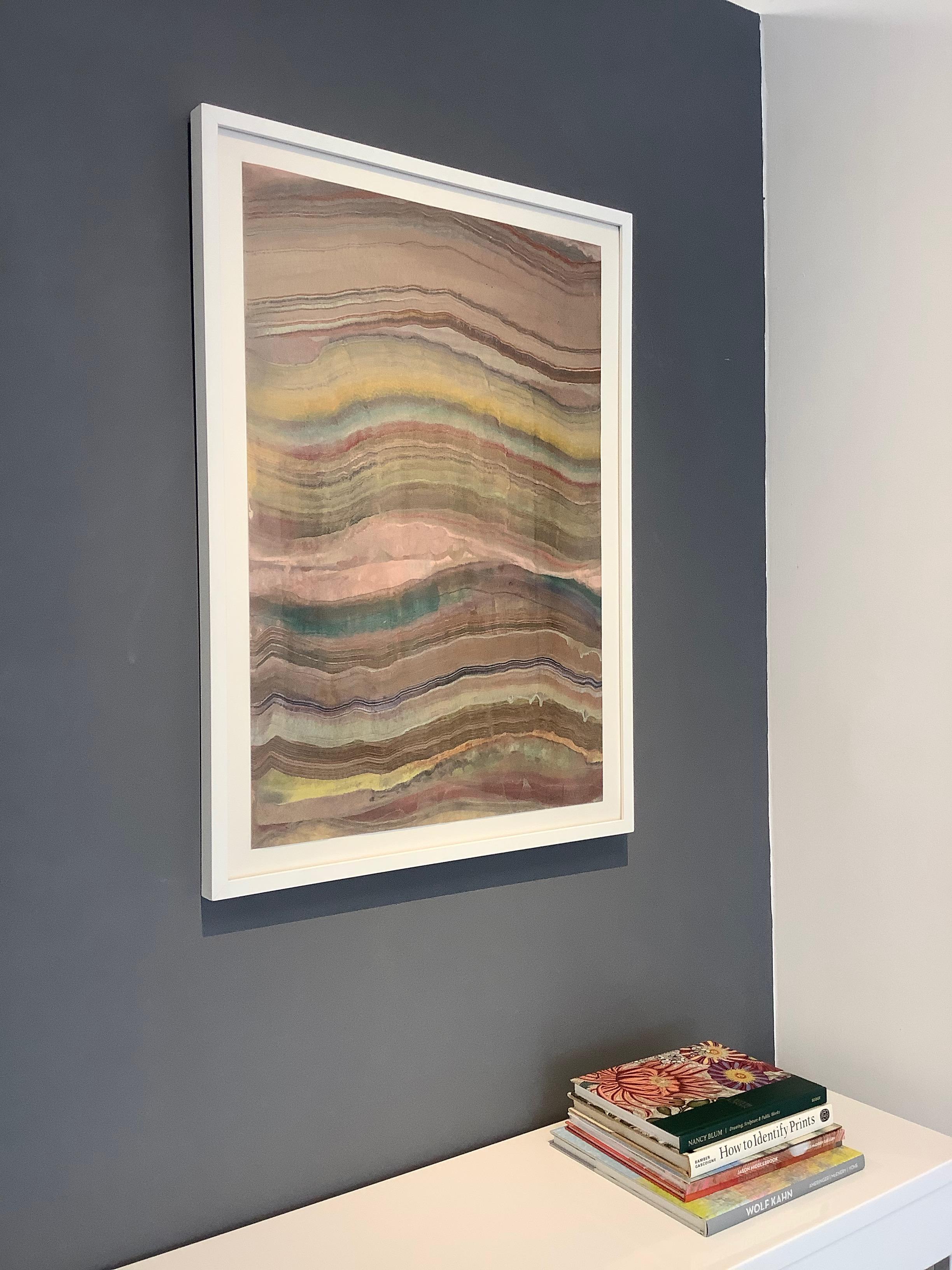 An abstract, multicolored encaustic monotype on paper with layers of pigmented beeswax on lightweight Japanese Masa paper create an undulating composition in brown earth tones suggesting layers of the earth's crust and geological formations with