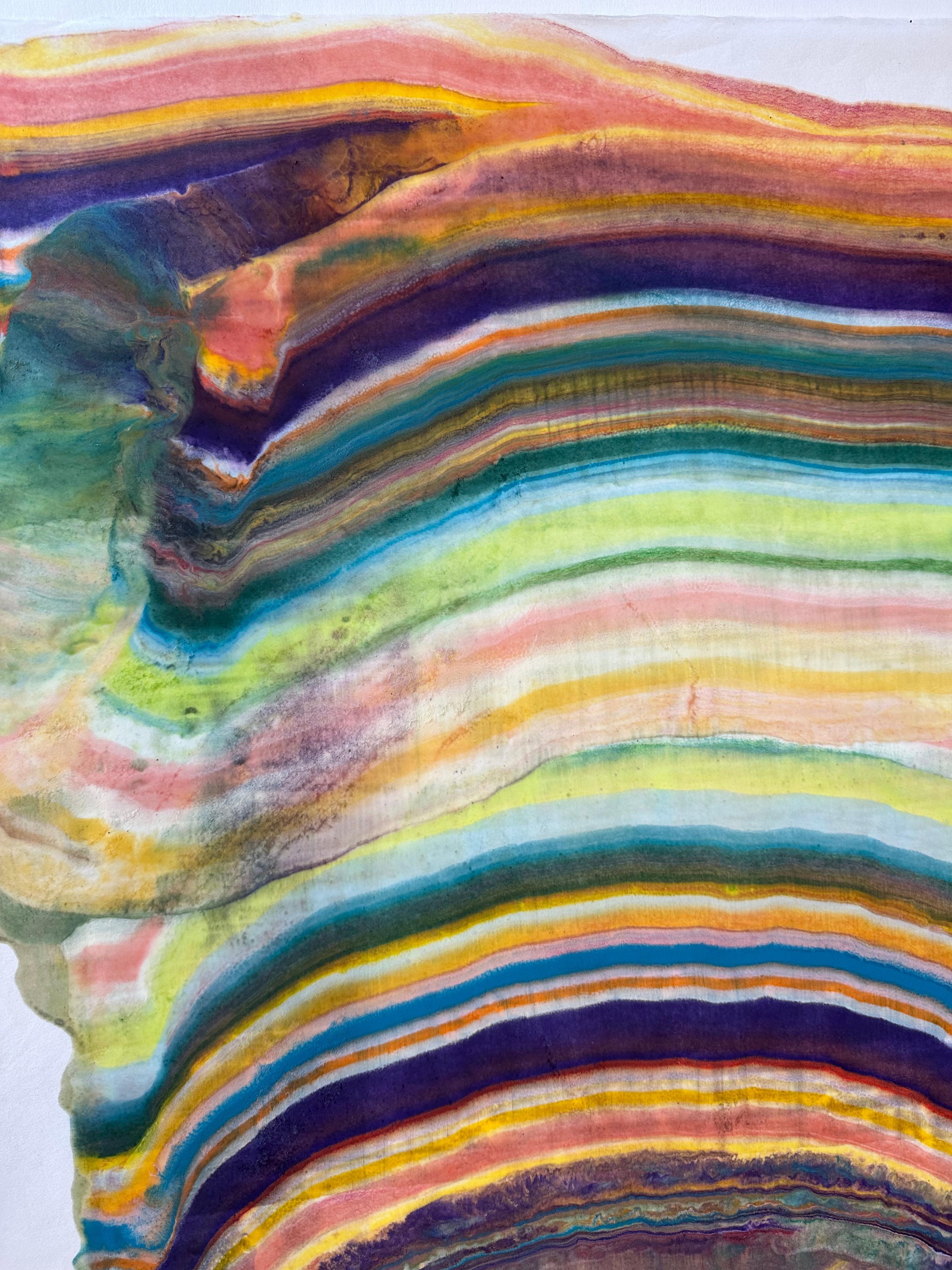 Laura Moriarty's Talking to Rocks 5 is a multicolored encaustic monotype on kozo paper. Layers of pigmented beeswax on lightweight paper create an undulating composition suggesting layers of the earth's crust and geological formations in bright