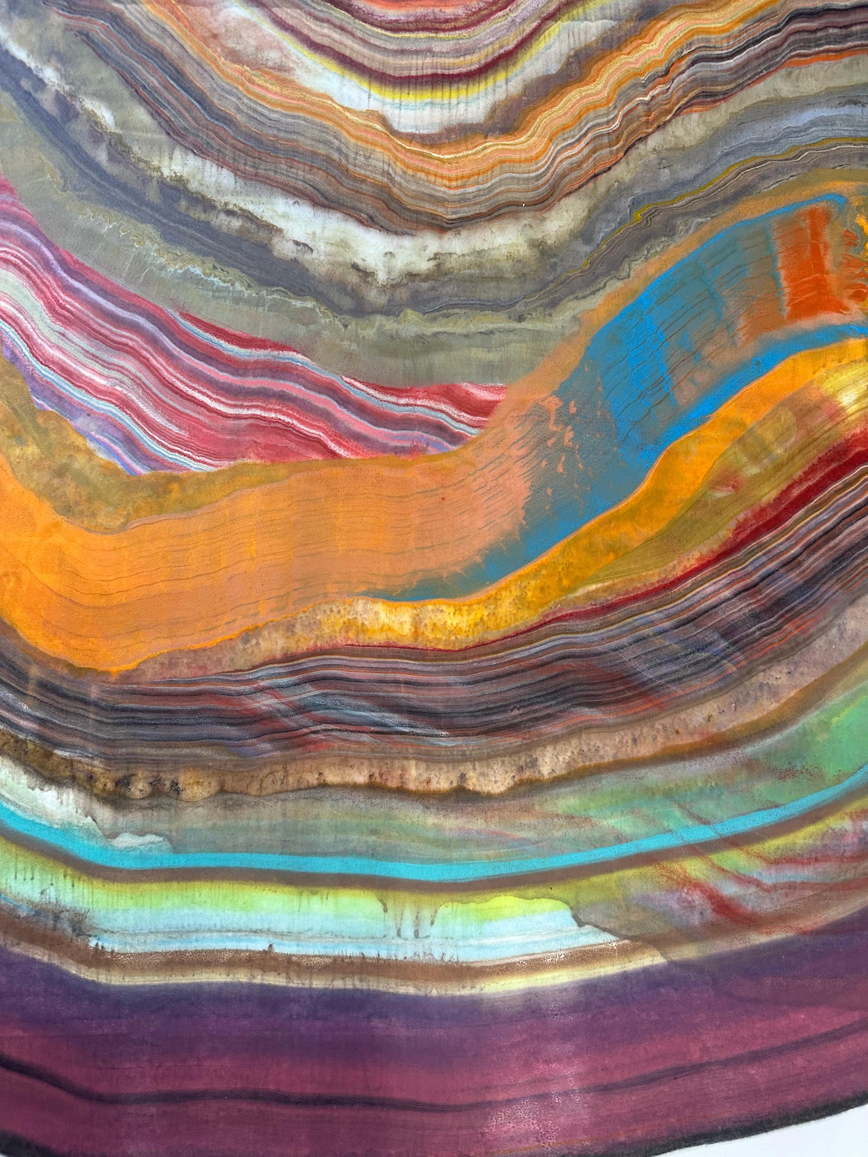 Laura Moriarty's The Wild Uncut World is a multicolored encaustic monotype on kozo paper. Layers of pigmented beeswax on lightweight paper create an undulating composition suggesting layers of the earth's crust and geological formations depicted in