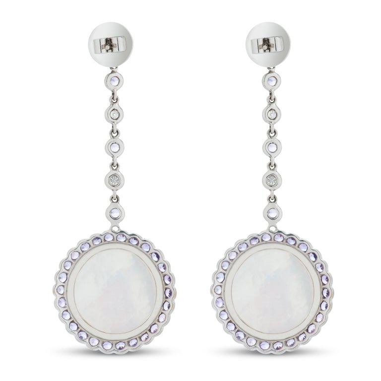 Laura Munder amethyst, diamond and mother of pearl dangle earrings in 18k white gold.

These earrings feature two modern rose cut amethysts totaling approximately 12.50 carats, set over mother of pearl.  The earrings contain an additional 3.87