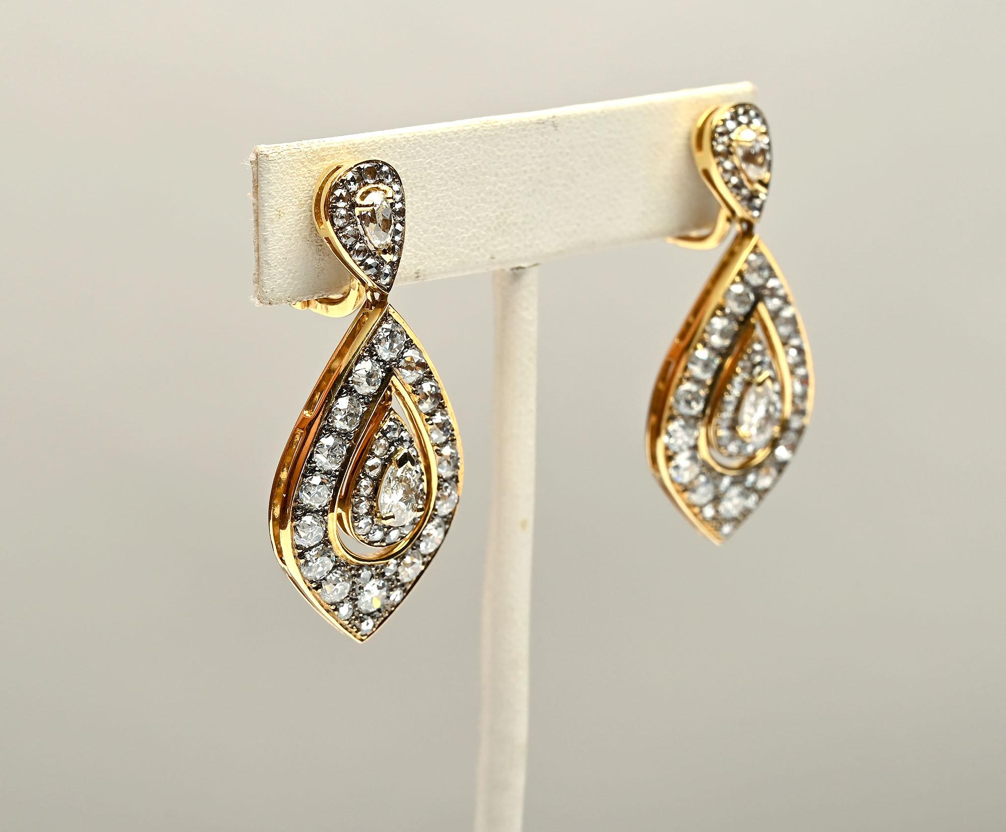 Stunning diamond drop earrings by Palm Beach designer, Laura Munder. The earrings have three pear shaped elements with a total of approximately 7.5 carats of diamonds. The stones are VS quality; GF color. The earrings measure 1 3/4 inches in length.