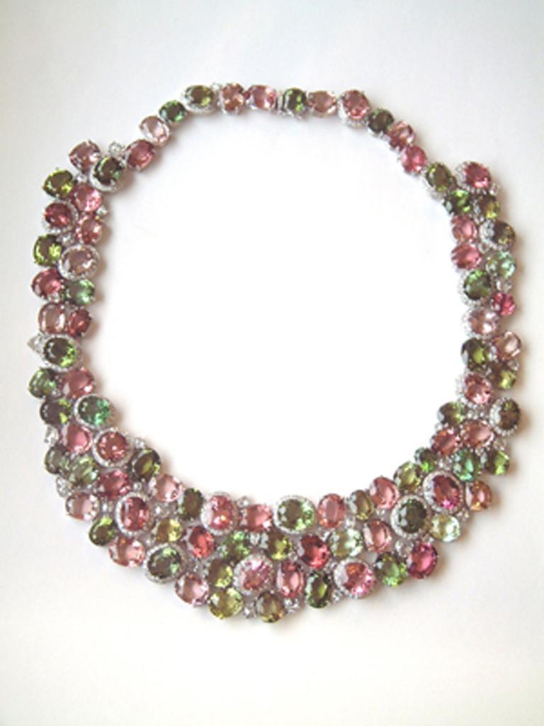 18 karat white gold bib necklace set with 92 faceted oval and round Pink and Green Tourmalines 244.63 carats total weight. Scattered throughout are 44 fancy shaped rose cut Diamonds 4.88 carats total weight. Surrounding 23 Tourmalines are 444 round