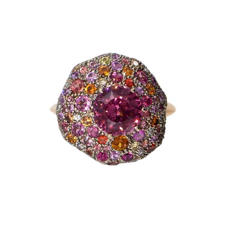 18 karat blackened white gold and rose gold ring the newest version of Laura Munder's popular  kaleidoscope ring set with one 8 mm round Pink Spinel 2.20cts. surrounded by one hundred forty-seven faceted round white, yellow and pink diamonds,