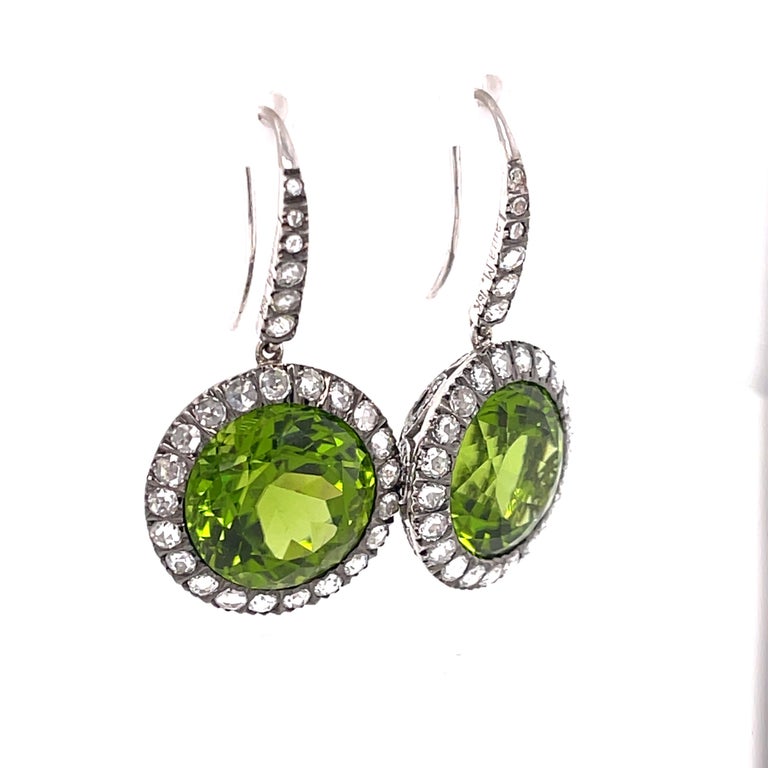 Gorgeous 18K Peridot and White Gold Earrings with Diamonds. These phenomenal earrings are drop earrings for pierced ears.  Round Faceted Peridot (21CTW)! 