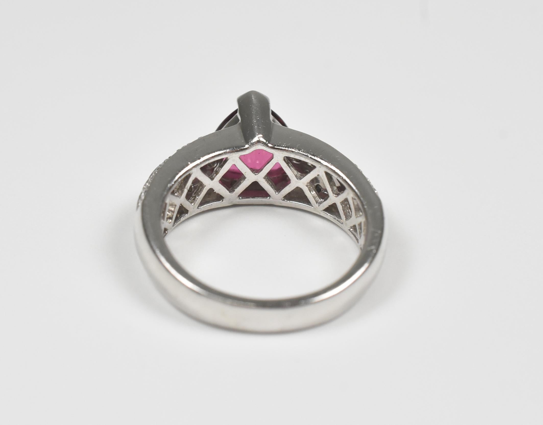 Laura Ramsey ladies platinum Rubellite tourmaline and diamond ring, size 8. Center triangular Rubellite Tourmaline stone measures 9mm x 9mm, 0.5 carat of diamonds flank the sides of the ring. Stamped LR and platinum, tested, light scratches as