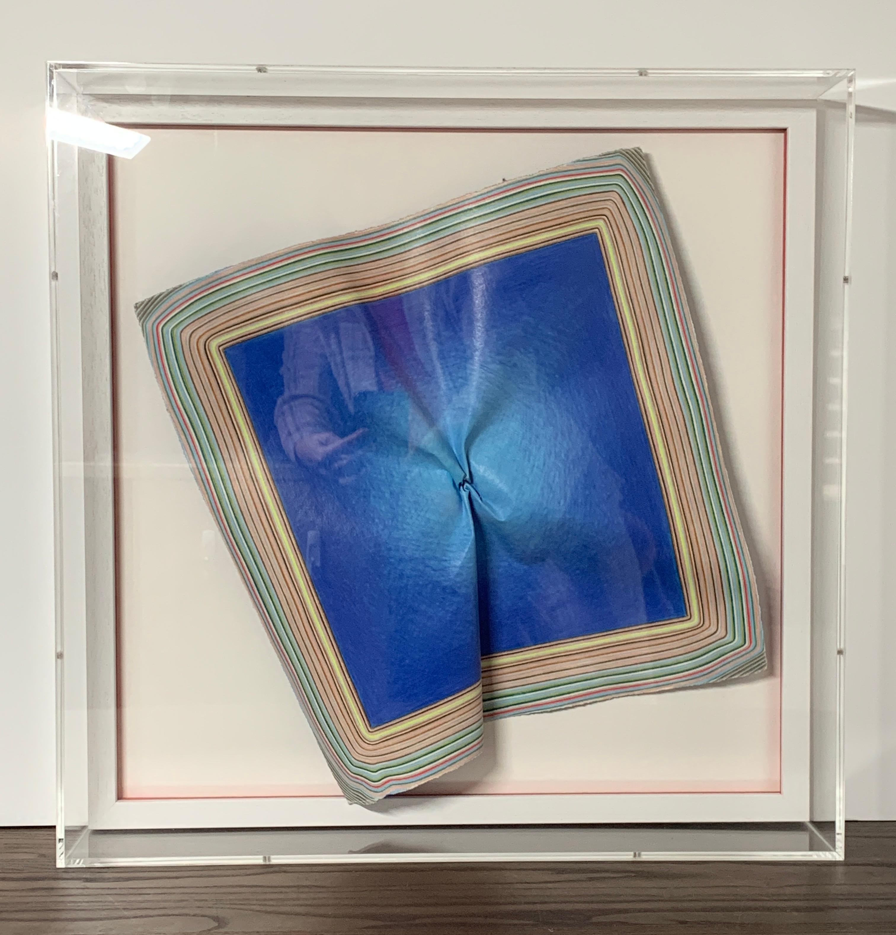 Blue Square is a sculpted drawing that wants to escape the bounds of its boxed-in frame. As there is no right side up, it may be displayed in any direction. The blue centre creates a space within the space. The drawn lines at the edges are trying to