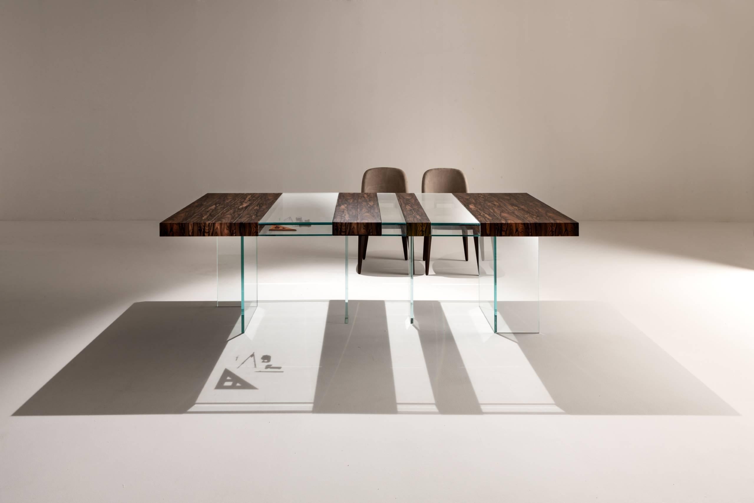 Rectangular table with modules in Ziricote and openable extra-clear crystal cases. Extra-clear crystal legs.

FINISH:
Ziricote and extra-clear crystal

The Elemento Table, also available in the Console version, together with the entire Moving