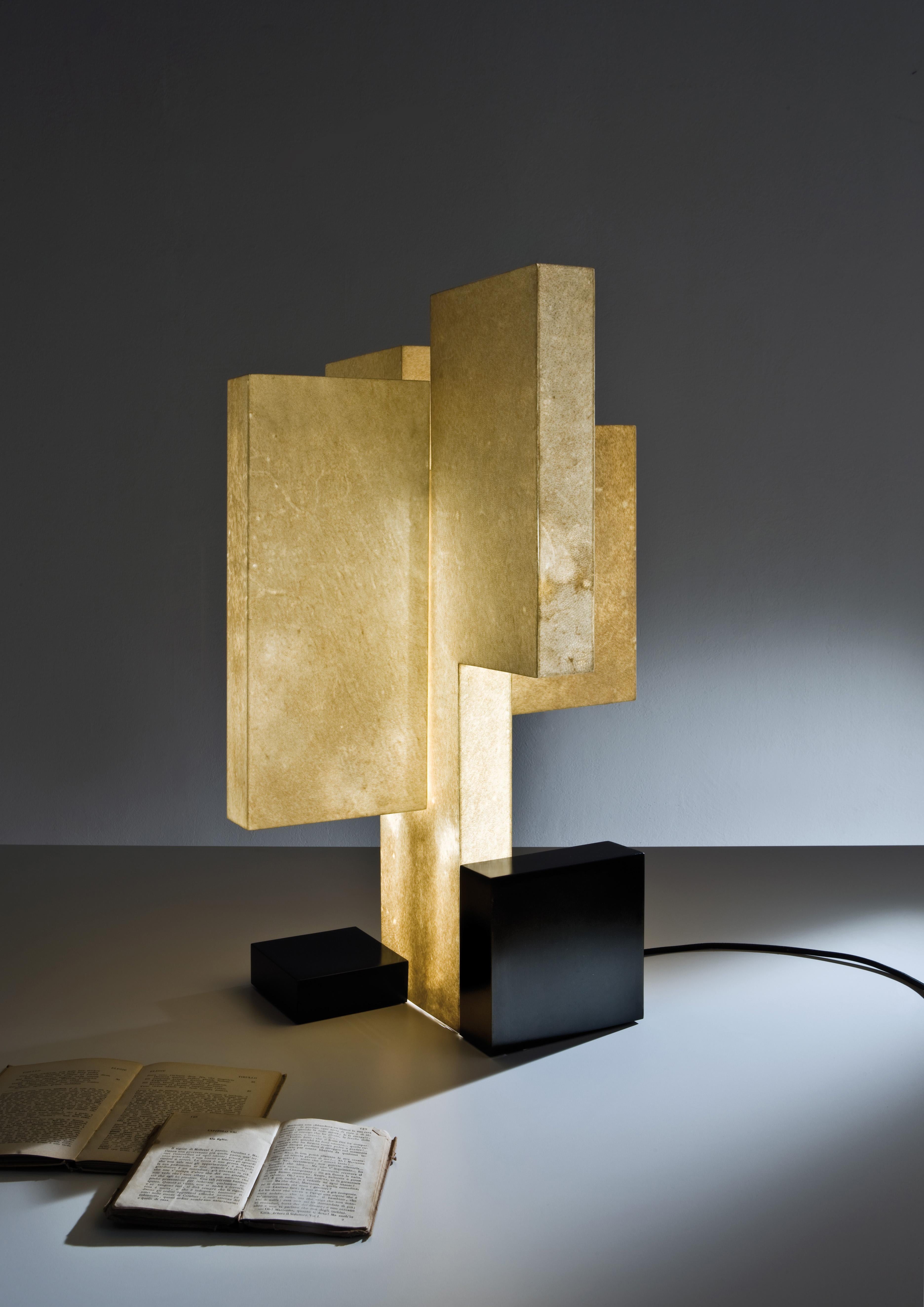 Table lamp with a diffuser covered in goat parchment, four internal LED strips and a burnished brass base.

FINISH:
Burnished brass and goat parchment

Laurameroni creates a collection of lamps with a modern design, where aesthetics and