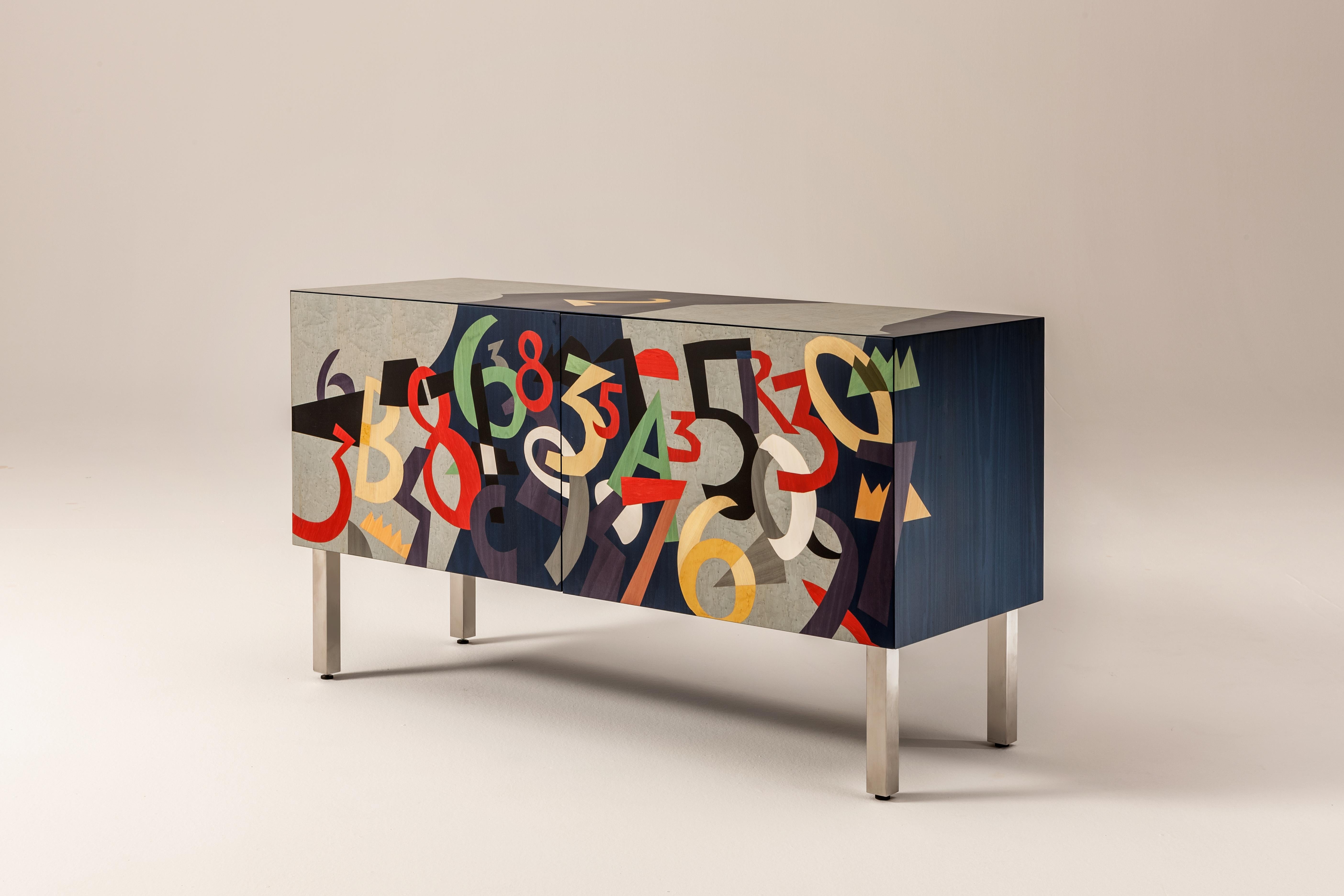 Sideboard with brushed metal legs and base, inlaid doors and structure. Fitted with push-pull doors and one internal shelf. It is also available in the hanging version.

FINISH:
Limited Edition Art Inlay

In Numeri, Pop artist Ugo Nespolo fills the