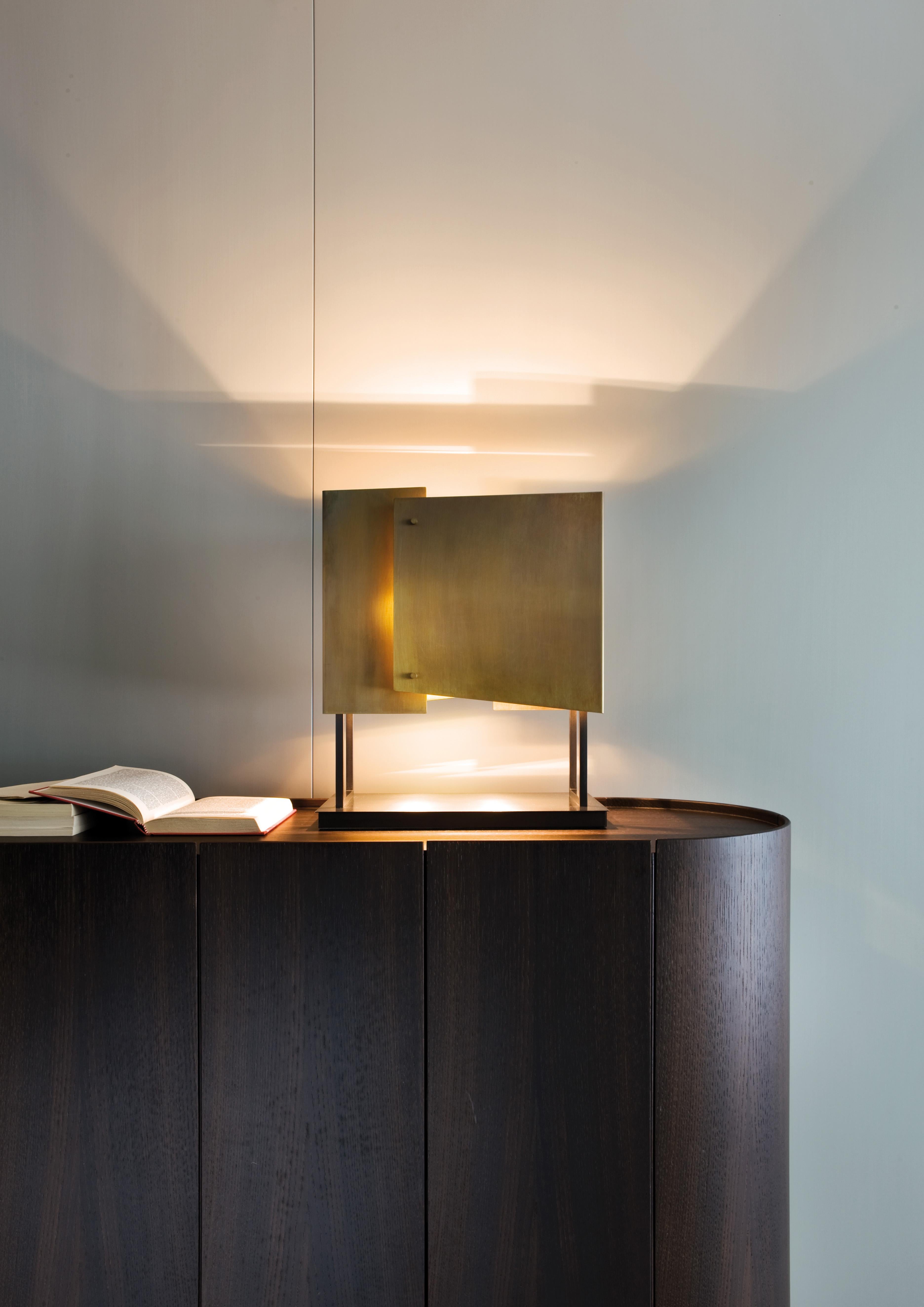 Table lamp with black nickel-plated brass structure and burnished brass lampshade.

The simple, refined and at the same time modern and creative design, is combined with the unique and original touch given by the hands of our craftsmen who make each