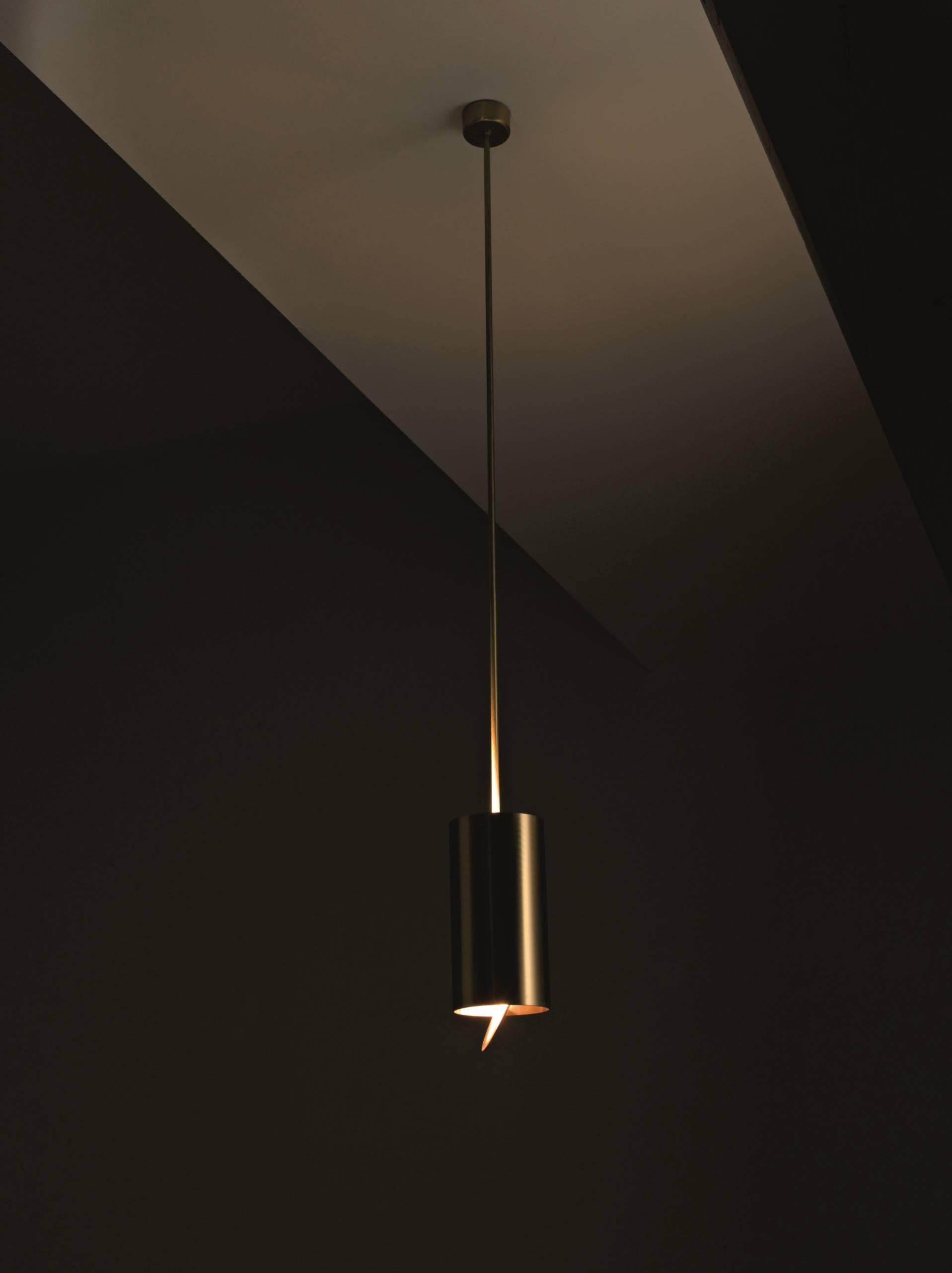Tubular hanging lamp with satin brass structure and adjustable lower disc.

The sophisticated design and the choice of the finest materials are the distinctive elements of our Lamps. Particular attention is paid to metals, especially copper and