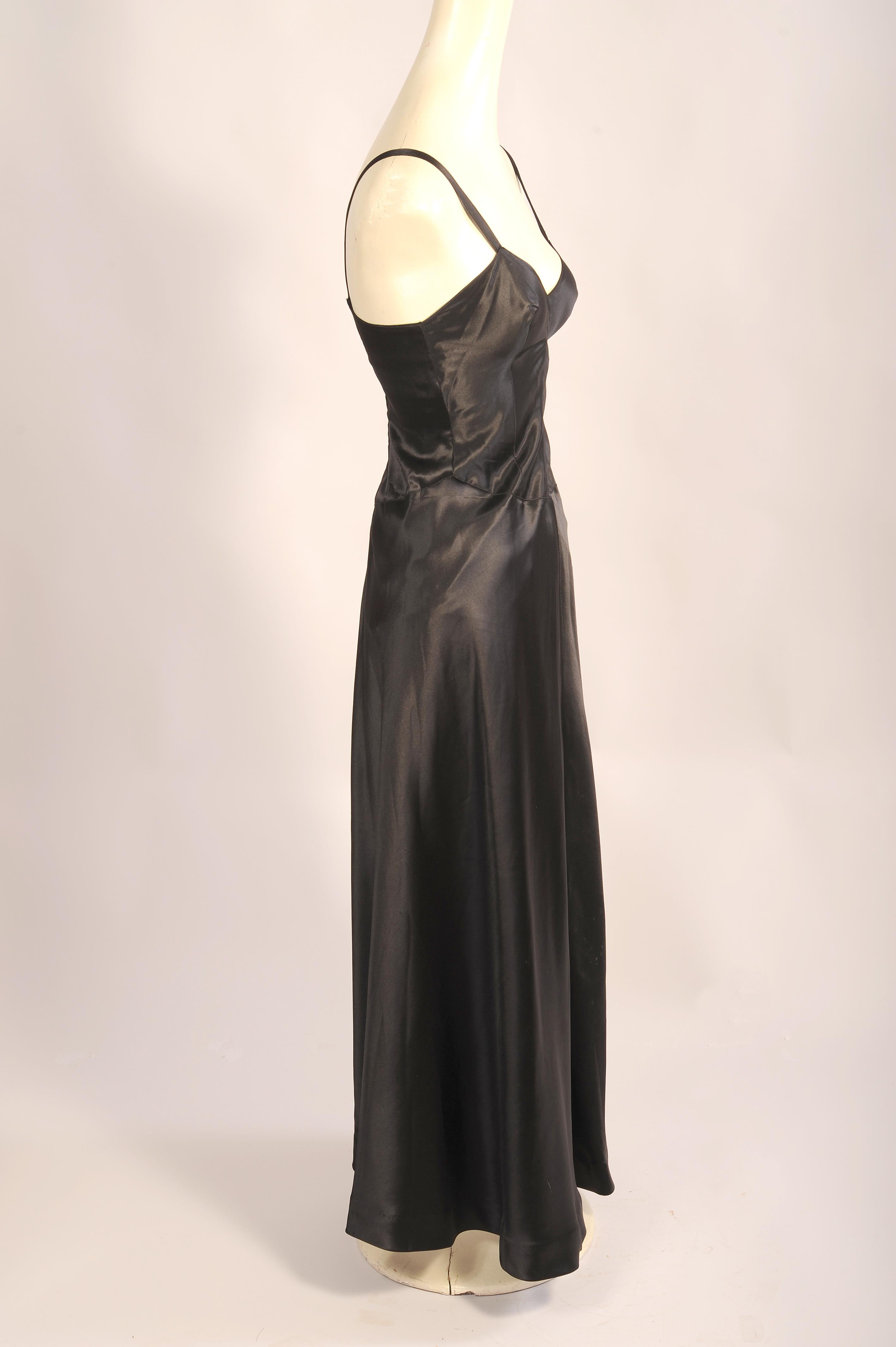 This is such an unusual design, a black bias cut silk satin slip/dress with garters as an integral part of the design which was created by laure Belin in Paris. She was a well regarded designer who held fashion shows at the finest hotels in paris.