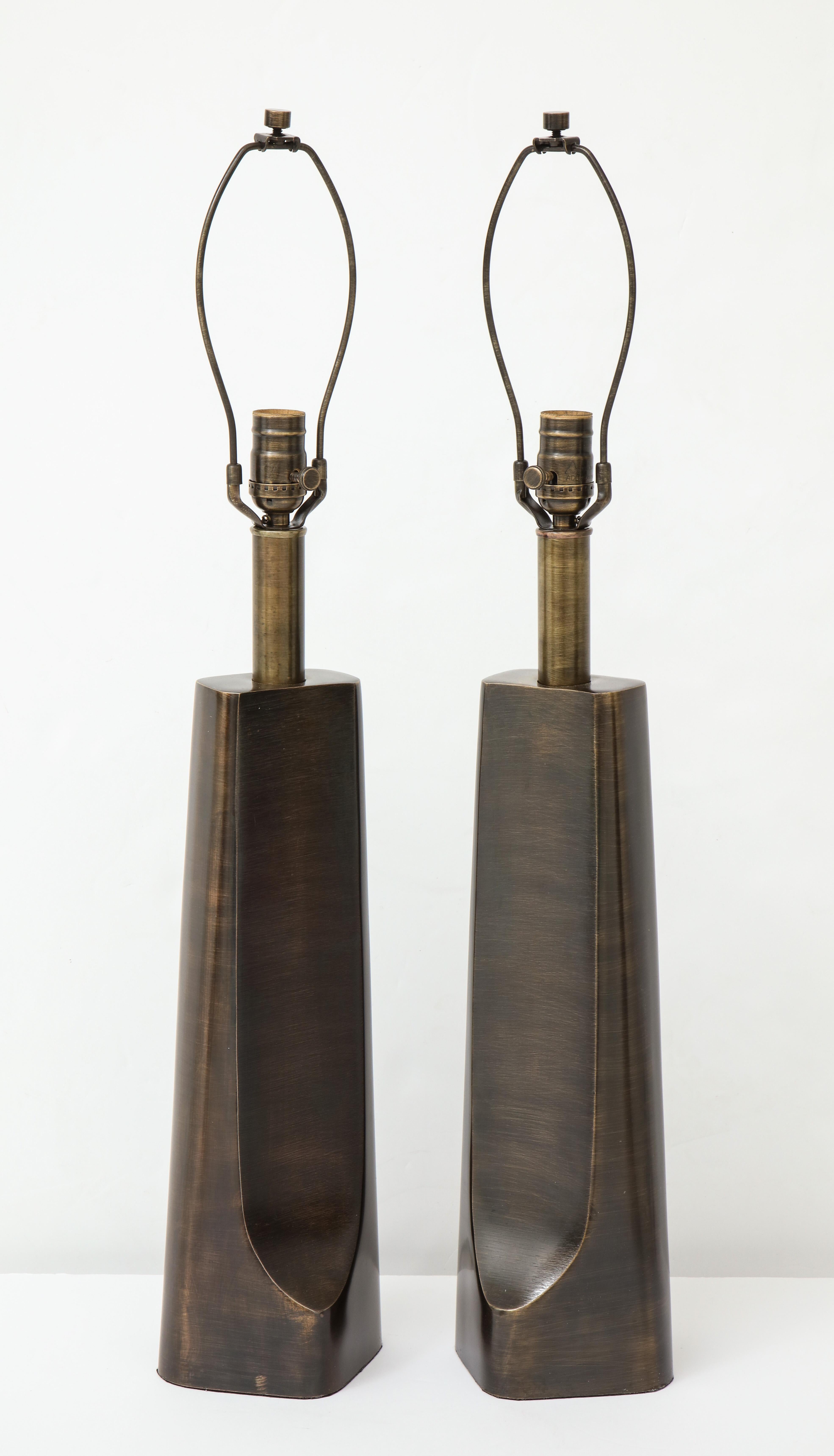 Pair of aged bronze sculptural modernist lamps with a slim profile. Rewired for use in the USA. 100W bulbs max.