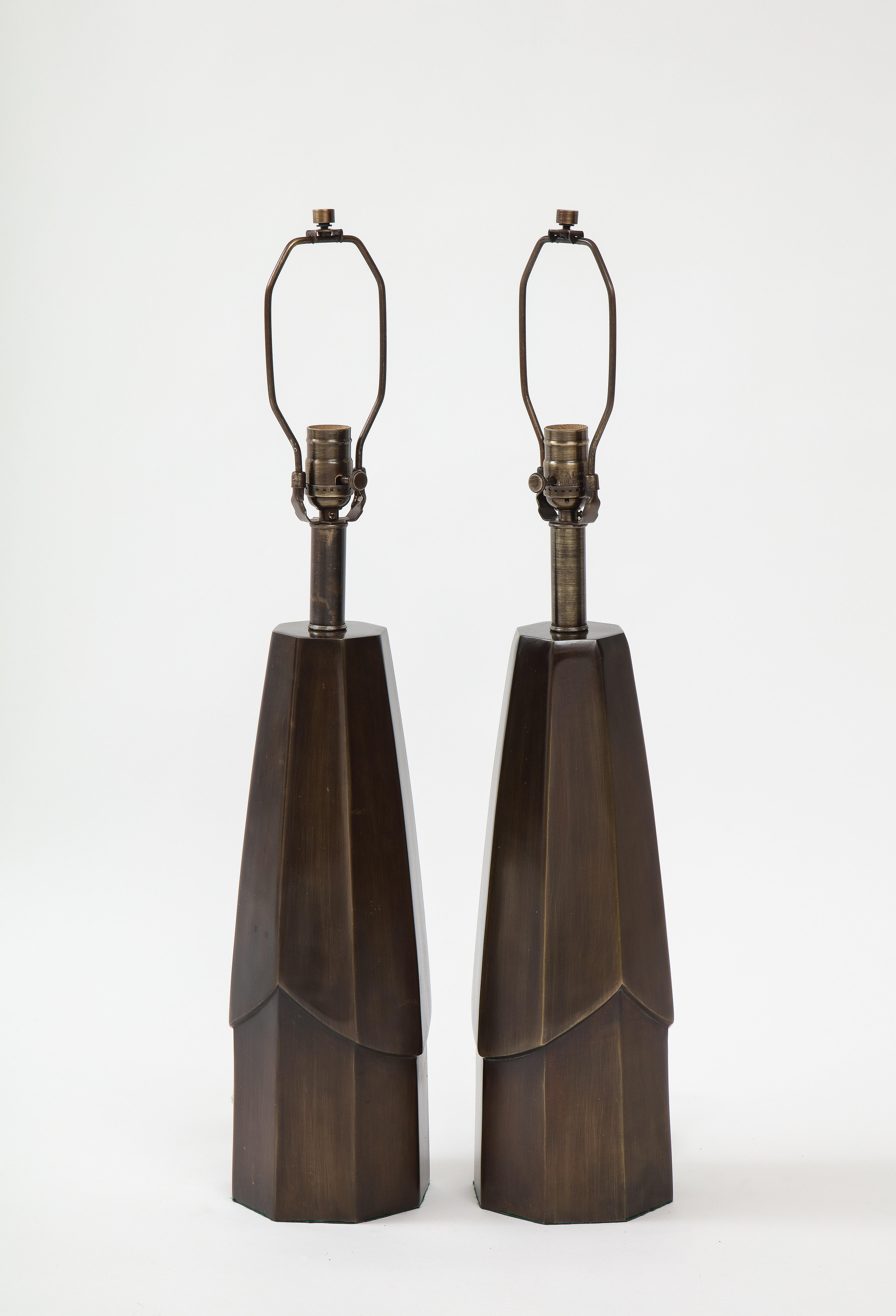 Pair of Brutalist style dark bronze lamps with faceted bodies.. Lamps have been rewired for use in the USA, 100W max.