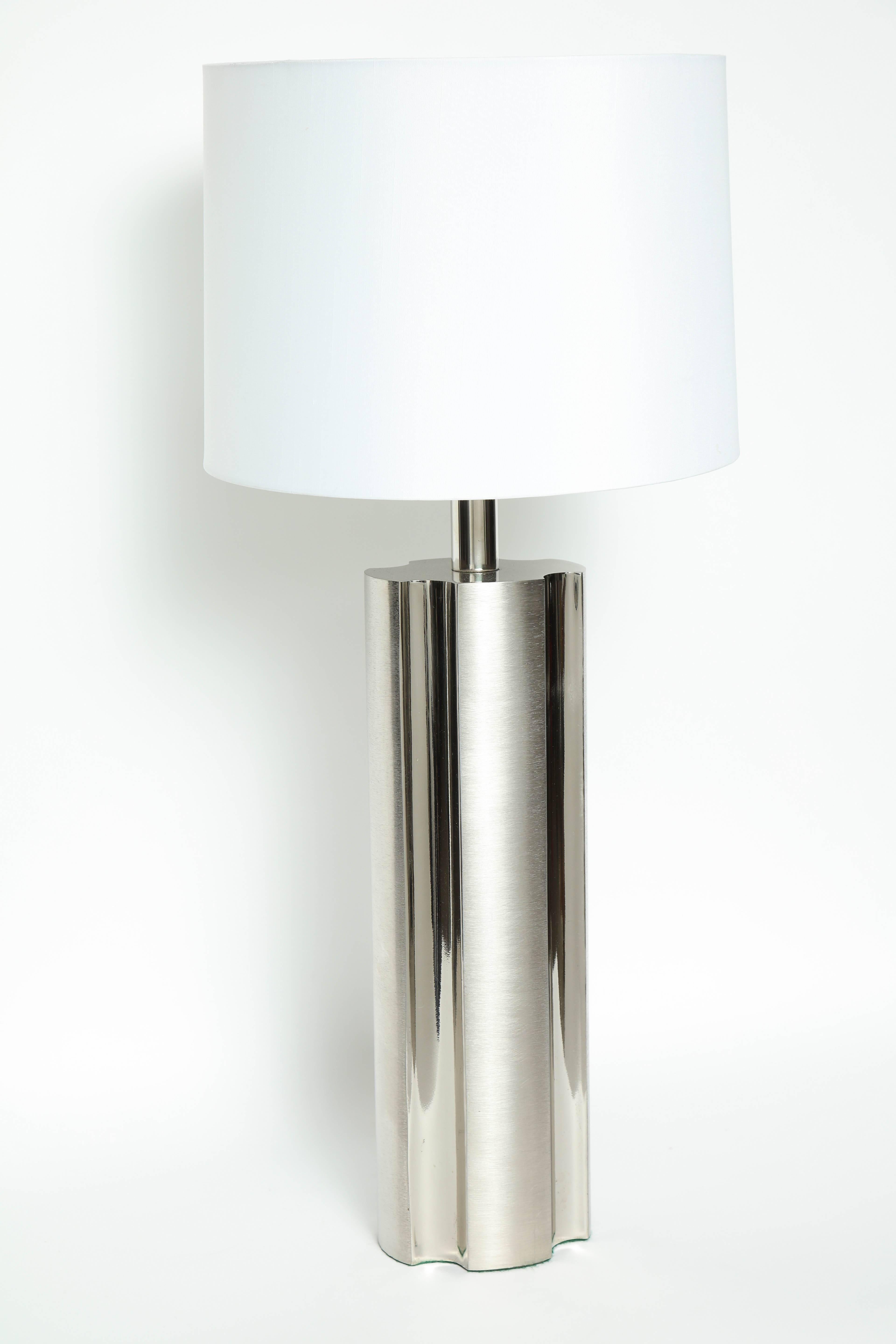 Pair of modernist fluted brushed steel column lamps with contrasting polished steel indentations. Lamps have been rewired for use in the USA with clear cords and nickel sockets. Shades not included.