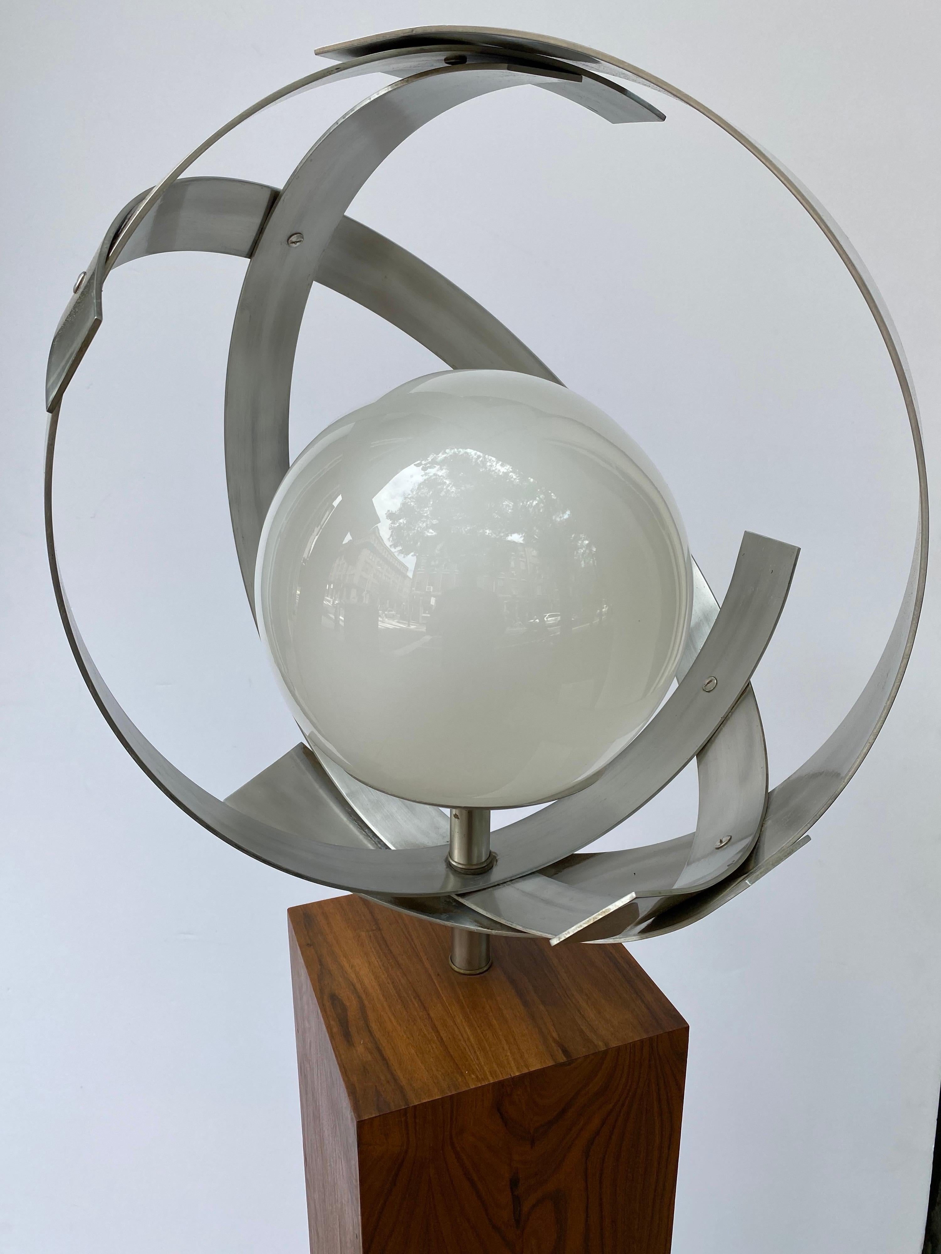 Laurel Lamp Company, walnut and aluminum with a round glass globe. Focal point of any room with this great looking lamp! Aluminum bands form a circle around a white glass globe. Light sits on a walnut pedestal all as one lamp!