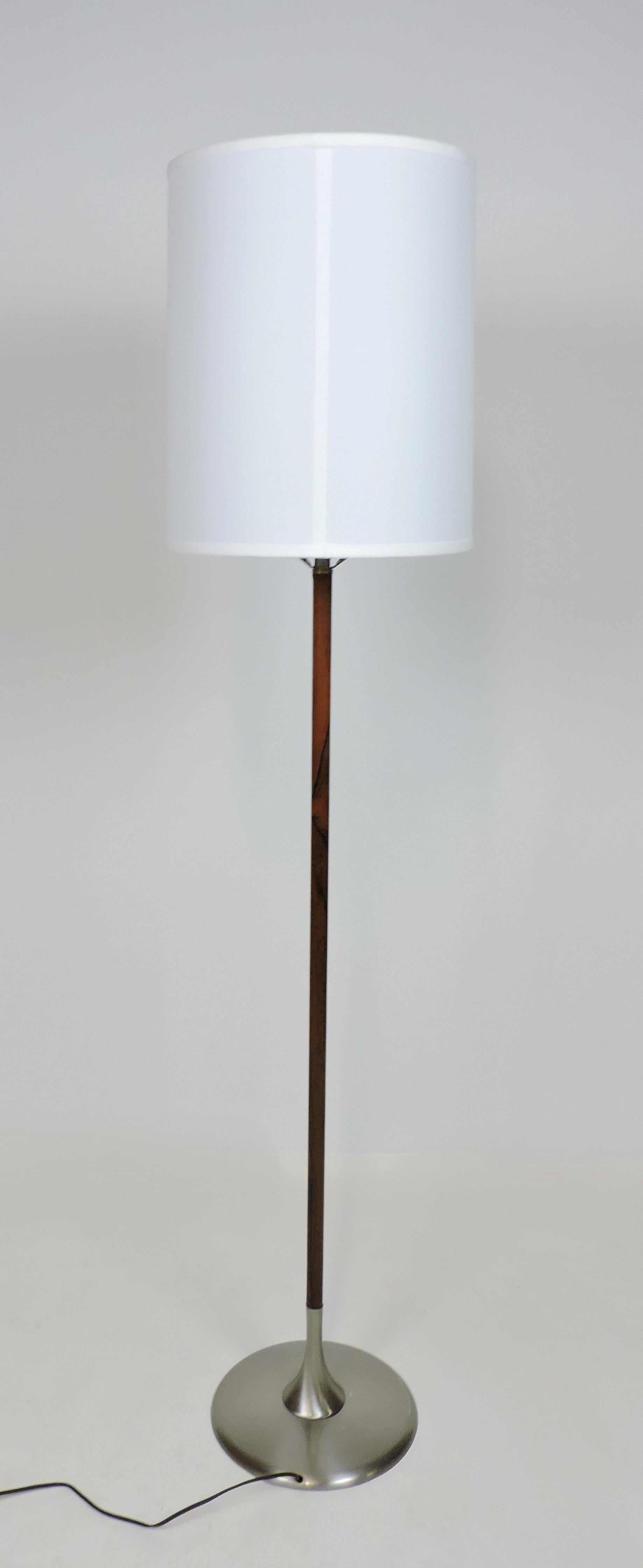 Handsome floor lamp made by high quality lighting manufacturer, Laurel Lamp Company of Newark, NJ. This heavy and well-made lamp has a brushed metal base, a rosewood veneered stem, and a new fabric shade. It takes a 3-way bulb.