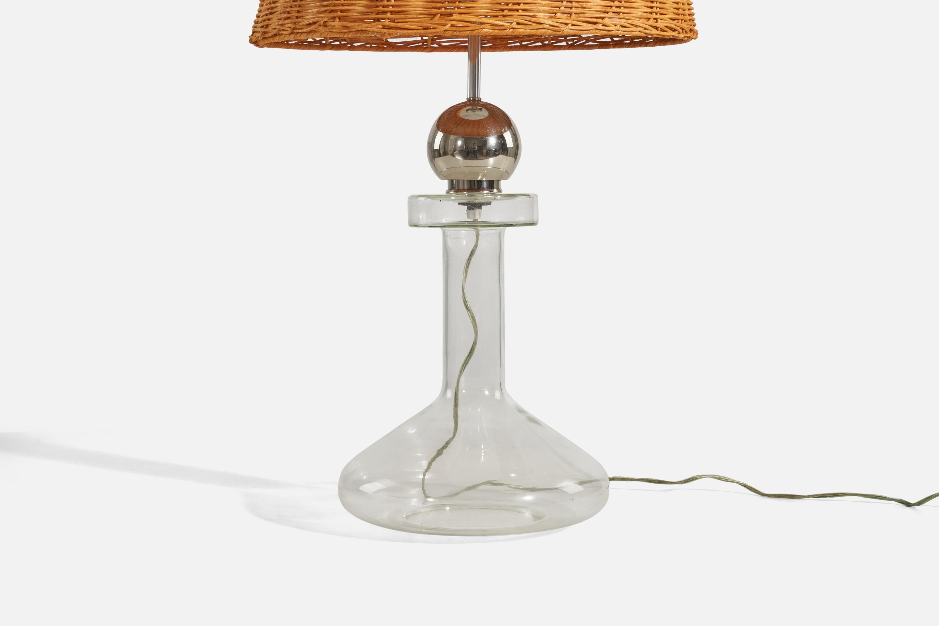A chrome metal, glass and rattan table lamp designed and produced by Laurel Lamp Co., 1970s. 

Sold with Lampshade(s)
Dimensions of Lamp (inches) : 21.12 x 10.25 x 10.25 (Height x Width x Depth)
Dimensions of Shade (inches) : 13.75 x 16.5 x 11.5