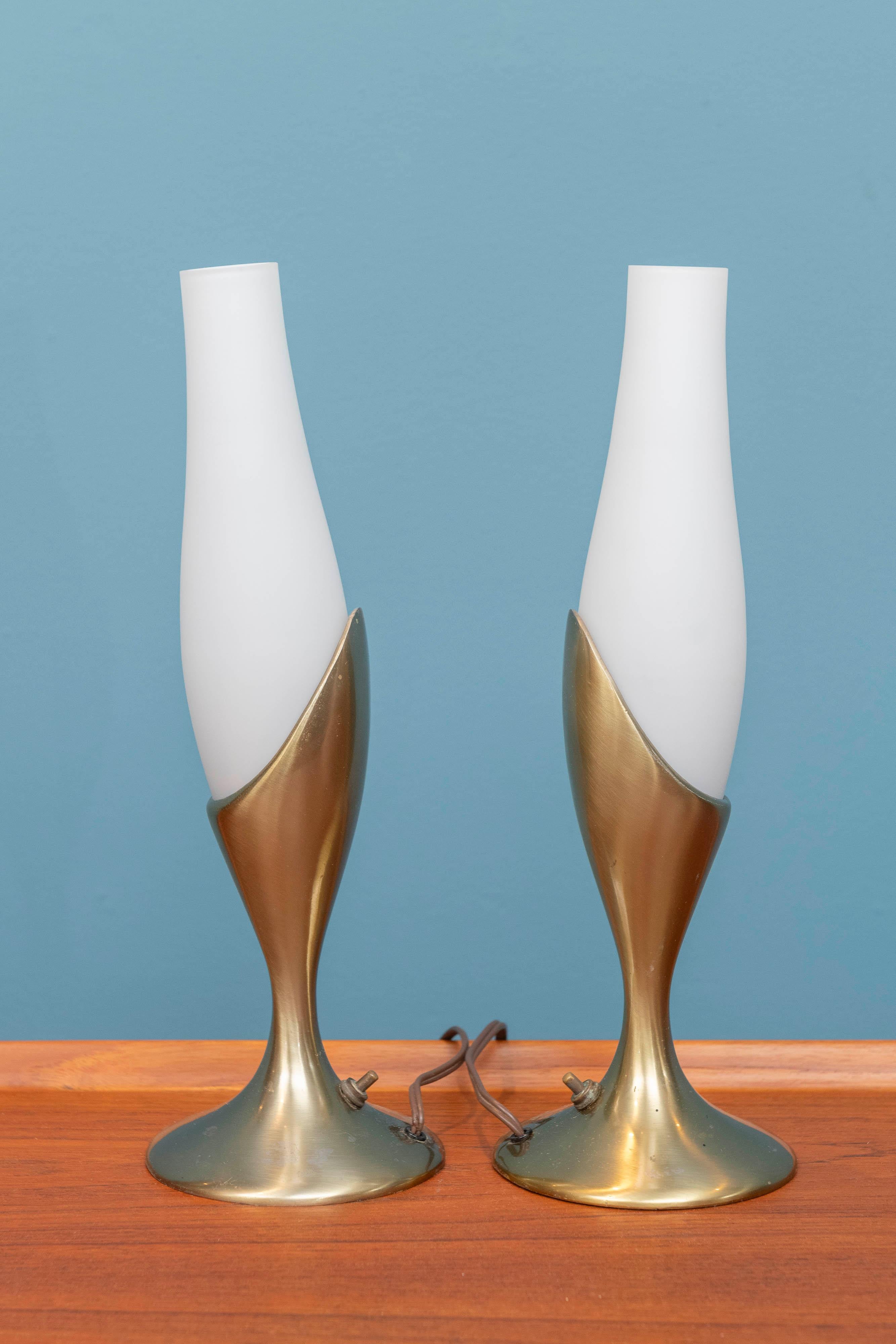 Pair of Laurel Lamp Company table or bedside lamps, U.S.A. Brass plated bases with Swedish blown glass tulip form opaque shades. Having base mounted switches that work as they should, showing age and use appropriate wear.