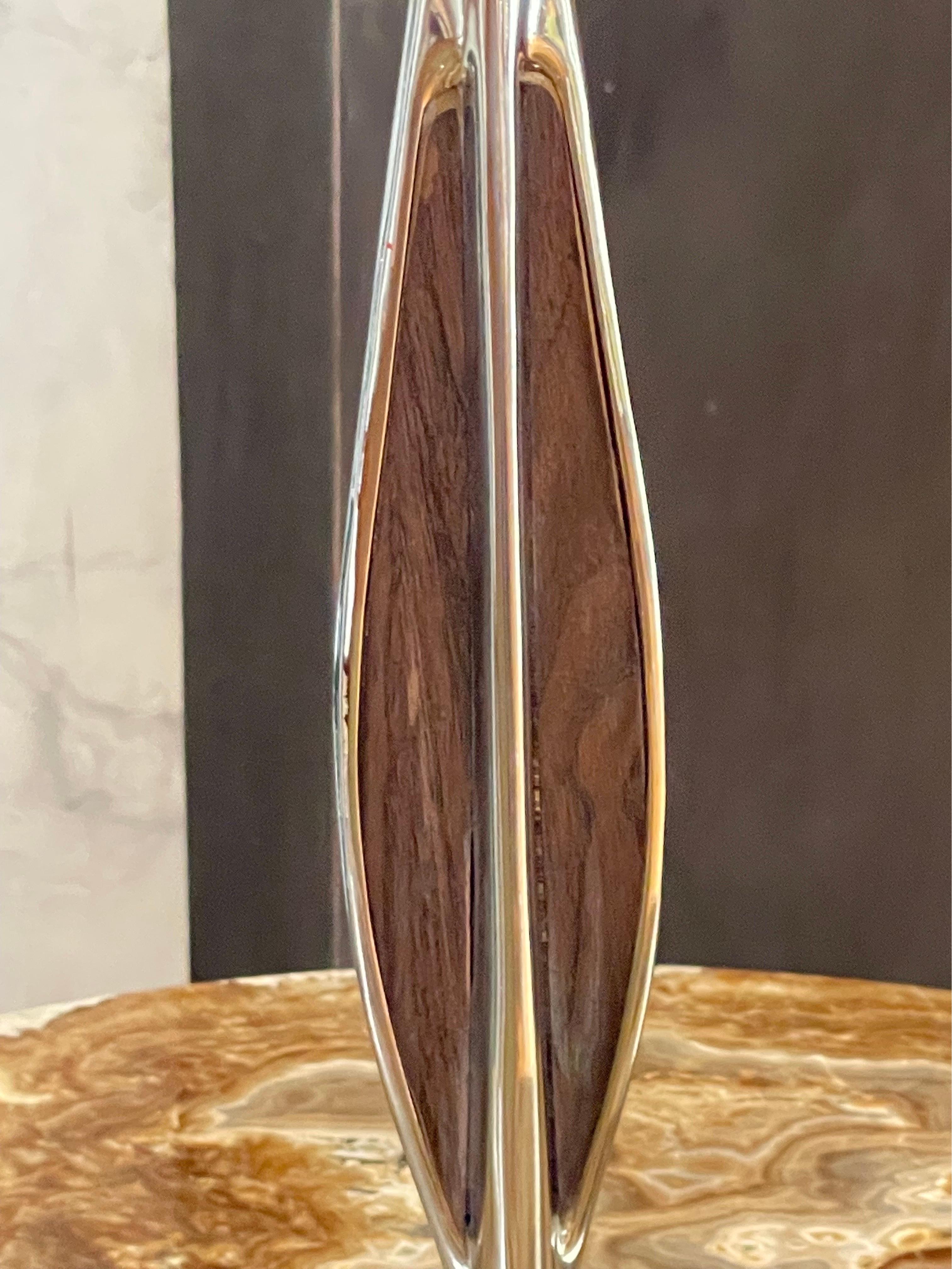 The Laurel lamp Mfg. Co. of Newark, NJ produced a variety of high quality mid century modern lighting and lamp products in the United States. The designers used walnut and other wood veneers on solid metal creating organic forms. Laurel Lamp Company