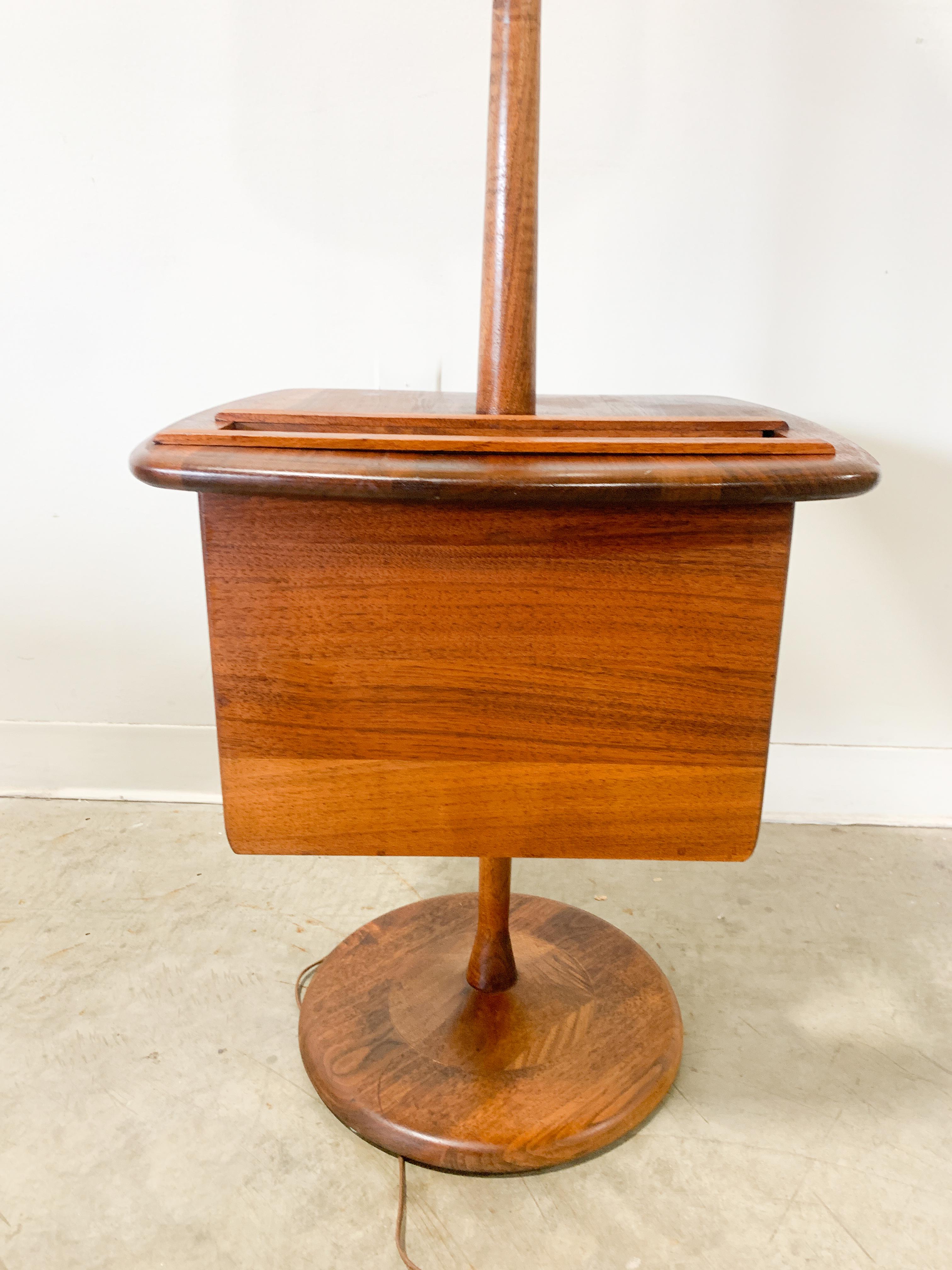 Beautiful solid walnut lamp table with built-in magazine or book rack. This classic mid-century modern design from the Laurel Lamp Company is functional and stylish with stunning wood grain. Vintage shade is in good condition with one or two