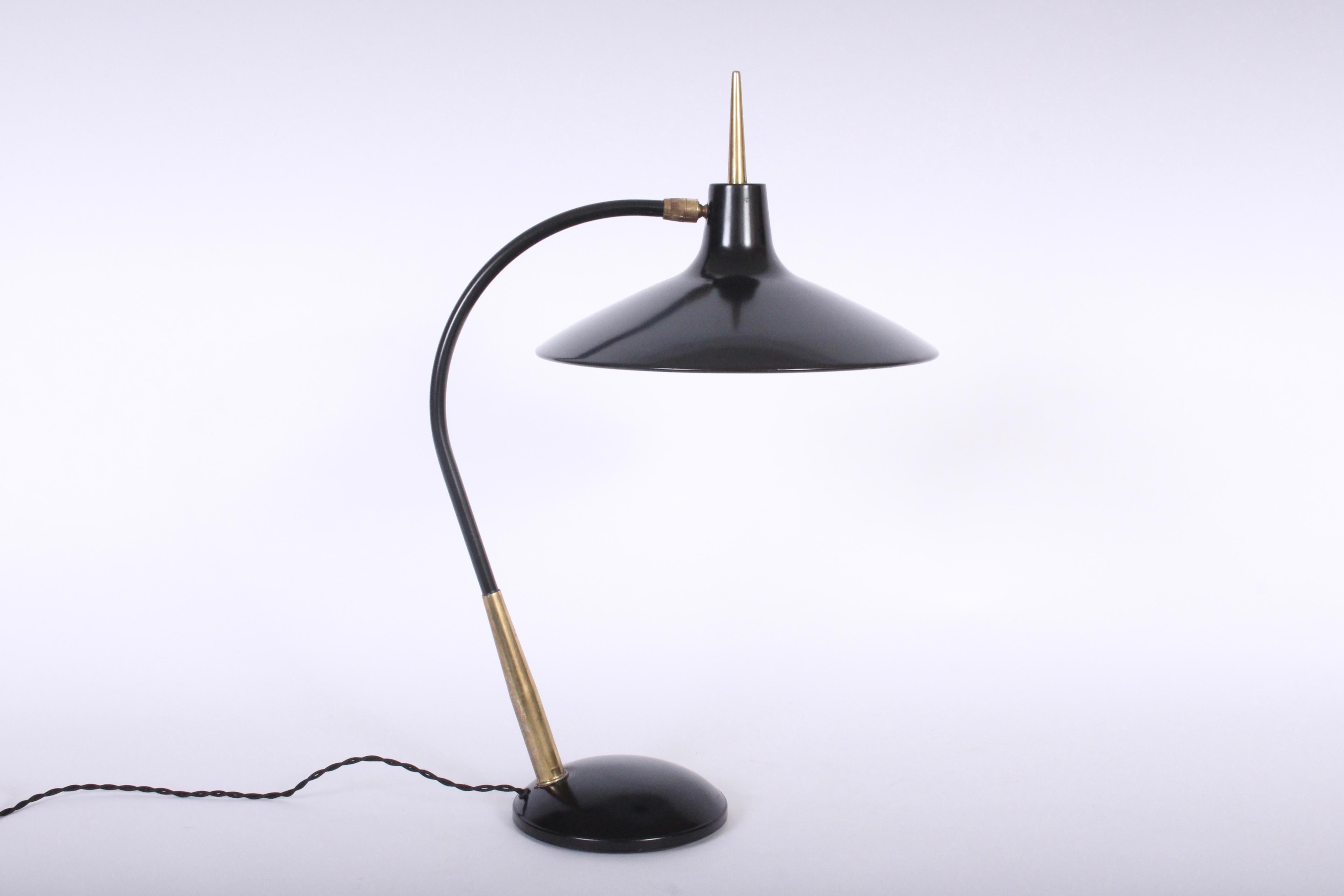 American Mid-Century Modern adjustable black enameled Laurel reading lamp in the style of Gerald Thurston. Featuring a black enameled shade, stem and base with patinated brass details. Adjustable tilt shade. Shade 15D. Base 6.5D. Without reflector