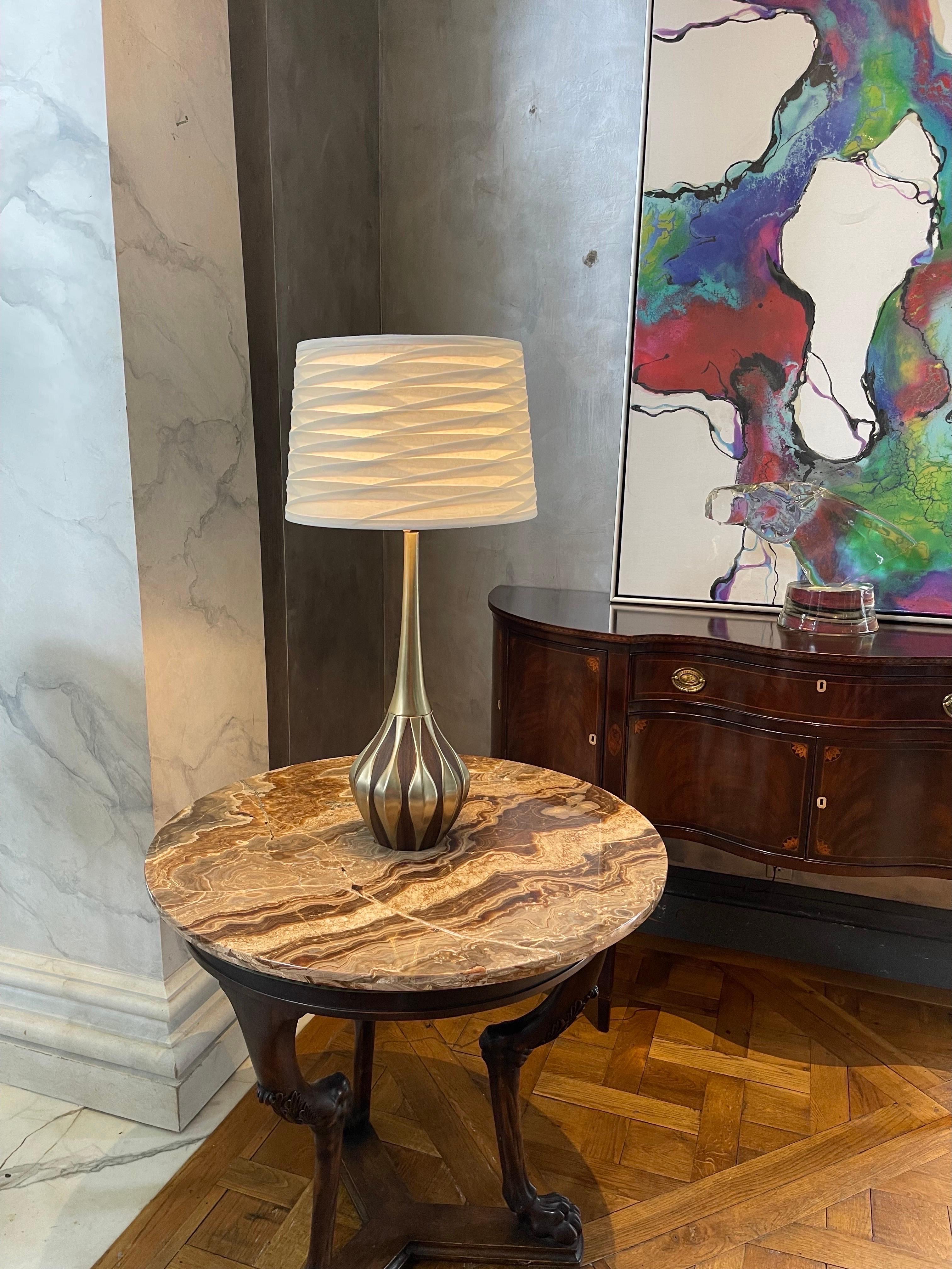 The Laurel Lamp Mfg. Co. of Newark, NJ produced a variety of high quality mid century modern lighting and lamp products in the United States. The designers used walnut and other wood veneers on solid metal creating organic forms. Laurel Lamp Company