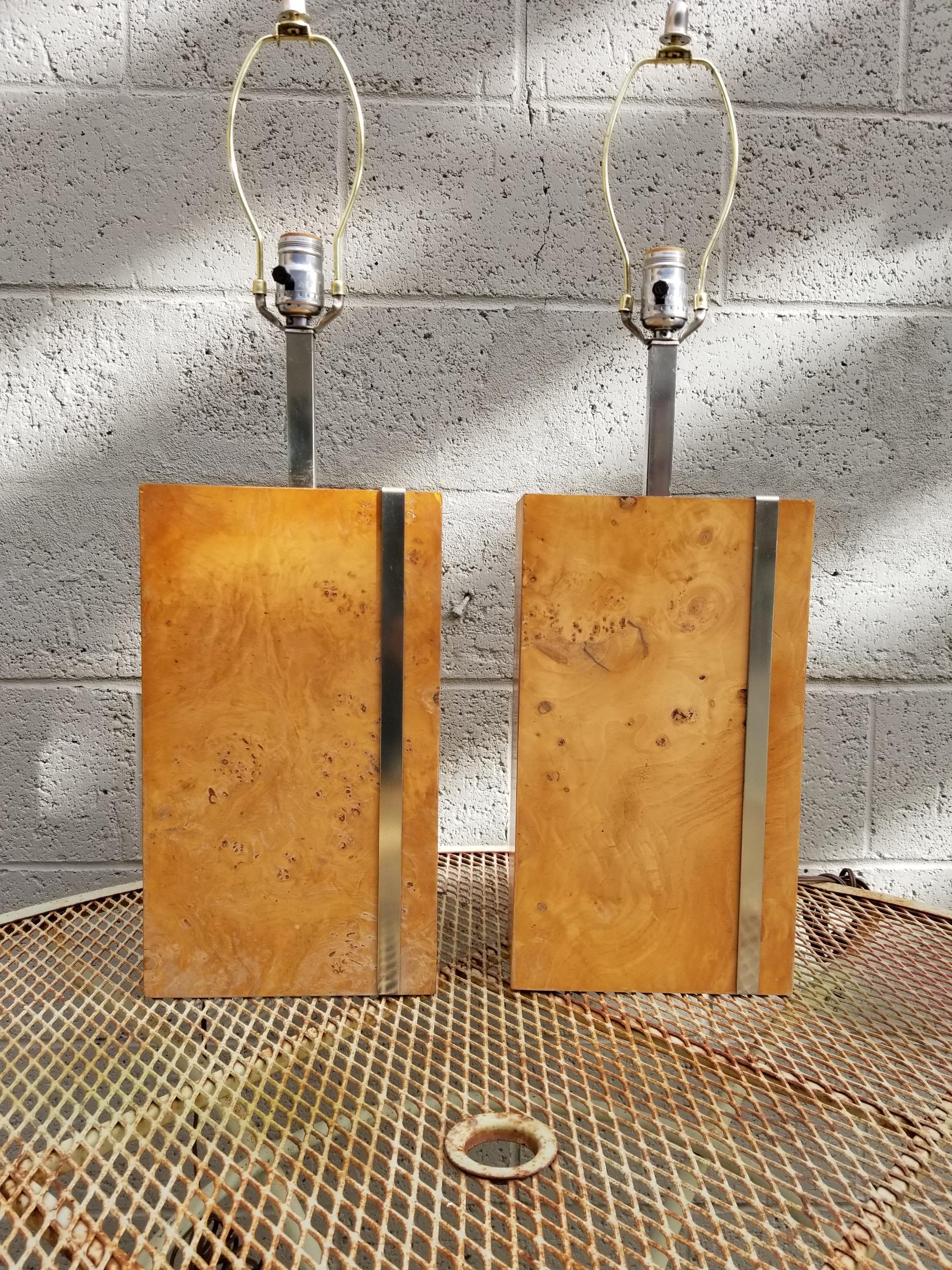A pair of rectangular burl- wood Mid-Century Modern table lamps by Laurel Lamp Company, circa 1970s. Wood appears to be olive burl. Chrome stem and chrome banding around base. In the manner of Milo Baughman and/or Paul Evans. Retain Laurel paper