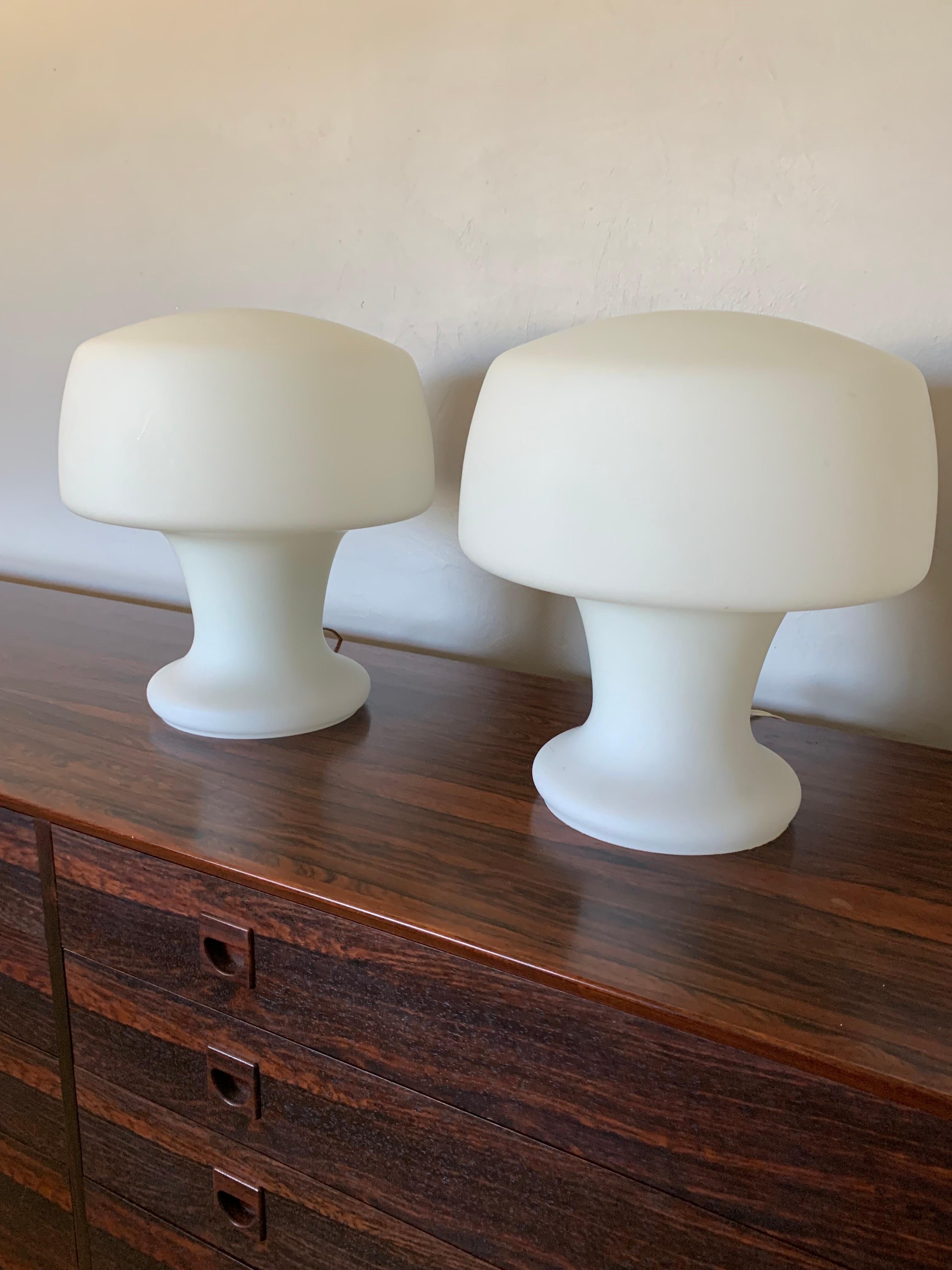 Fantastic pair of Laurel studio mushroom table lamps. Hand Blown opaque white glass forms a unique sculptural mushroom shape. Made from on solid piece of glass with a cord and switch to turn it on and off. True vintage piece. 

Mid century modern in