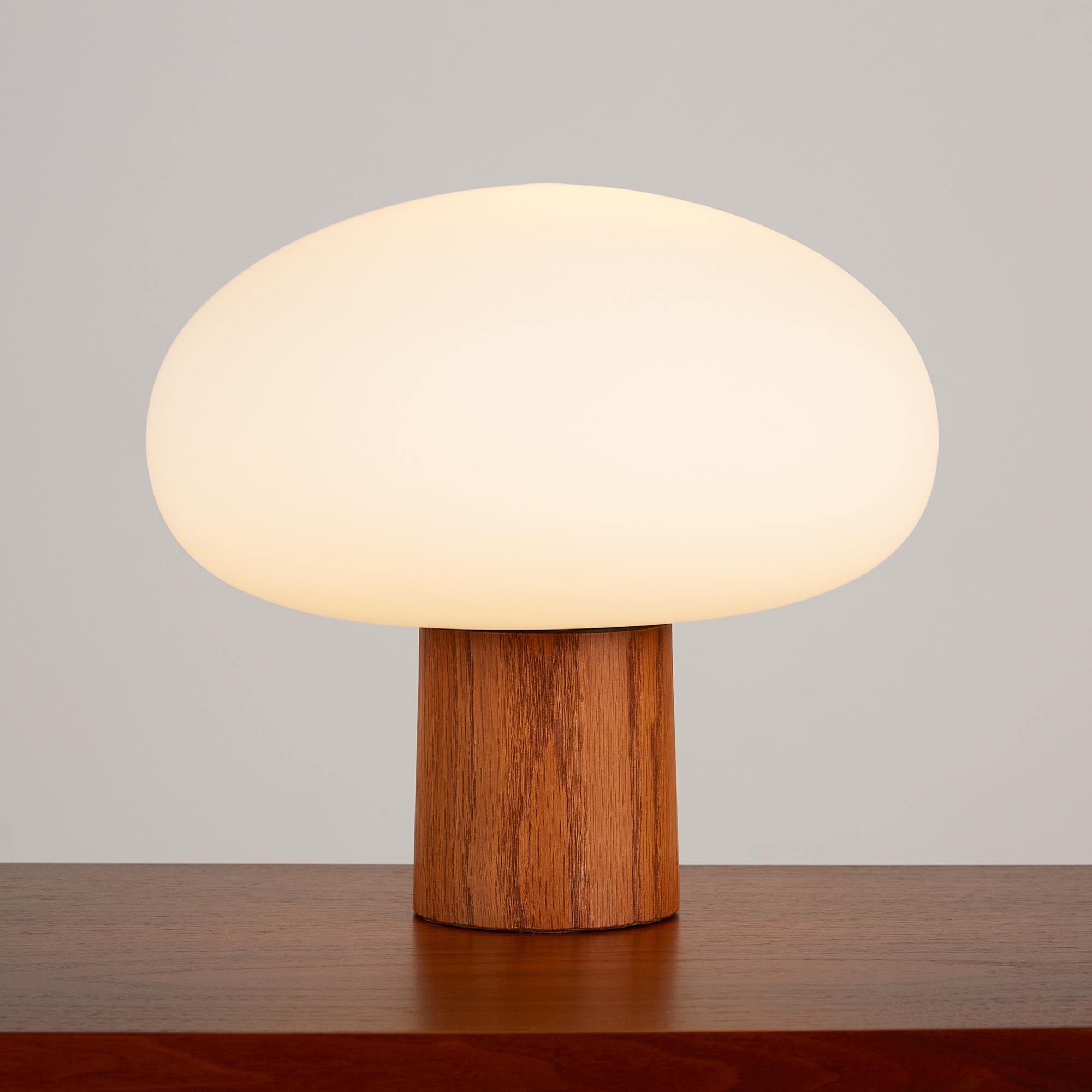 Mushroom table lamp by Laurel Lamp Company, c.1960s, USA. This lamp features a round frosted blown glass bulb and Walnut cylindrical base with the original brass rotary on/off switch. It's a beautiful piece to add mood lighting to any library or