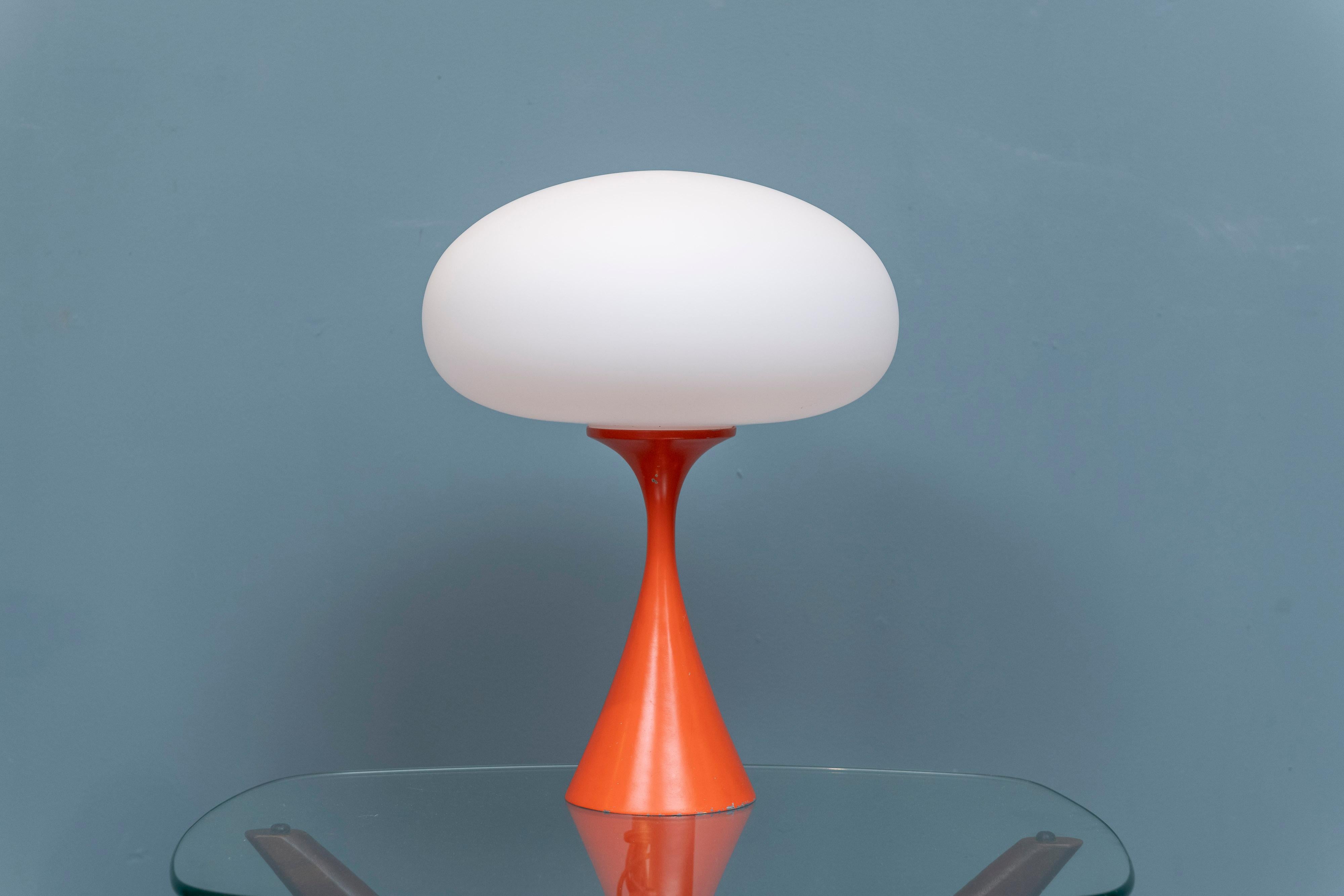 Laurel Lamp Company orange mushroom table lamp, U.S.A. Timeless modern design in a bright orange enamel with opaline glass shade. Has a three way socket for wattage variety 40-60-75 etc. base shows expected signs of use and wear but still presents