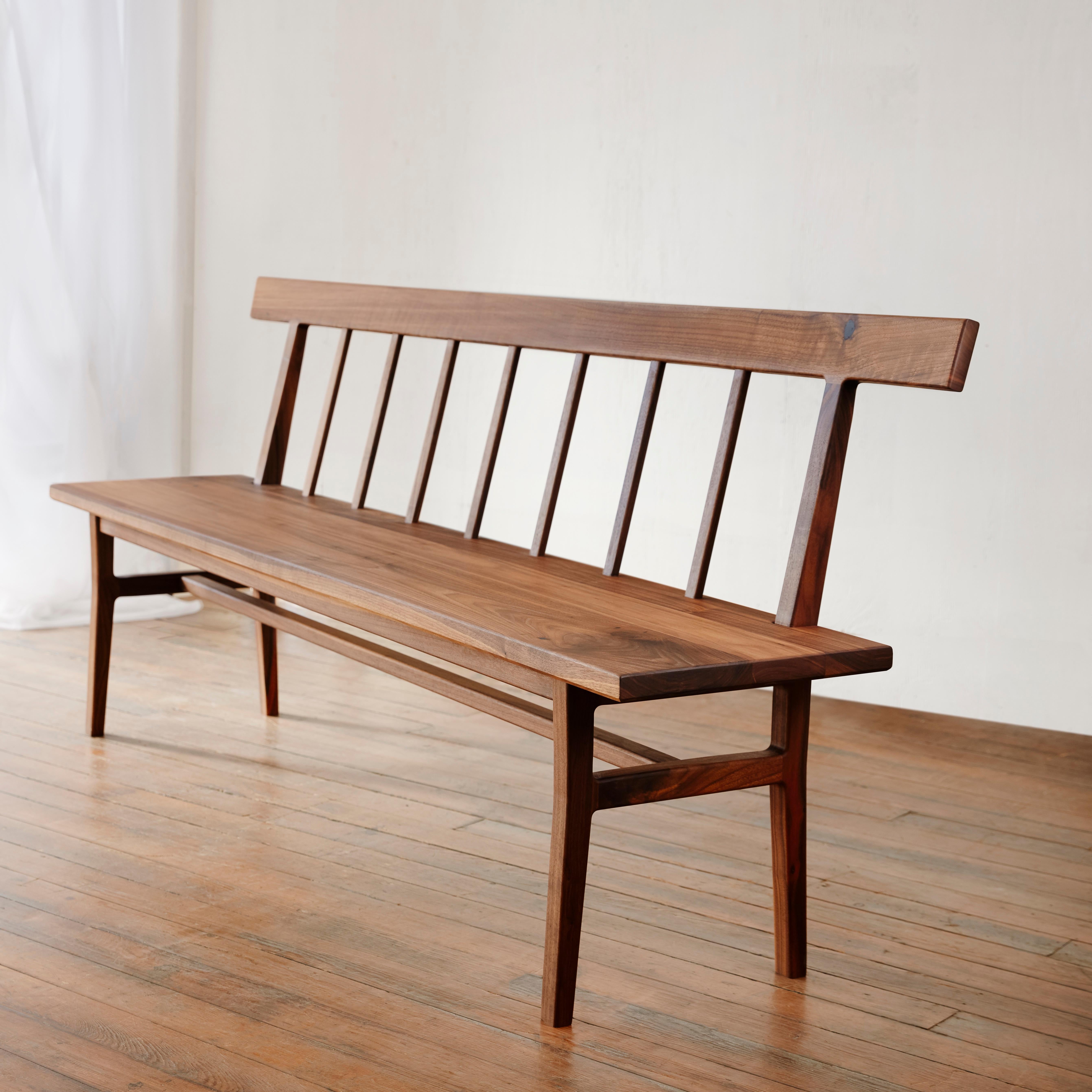 A clean modernization of a Classic Windsor bench, this settee features sculpted legs and slats instead of dowels and spindles. Constructed from sustainable walnut, the settee is artisan crafted with traditional joinery and finished with an